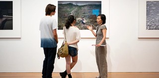 A Volunteer Guide engages visitors on a tour at GOMA / Photograph: N. Umek / © QAGOMA 