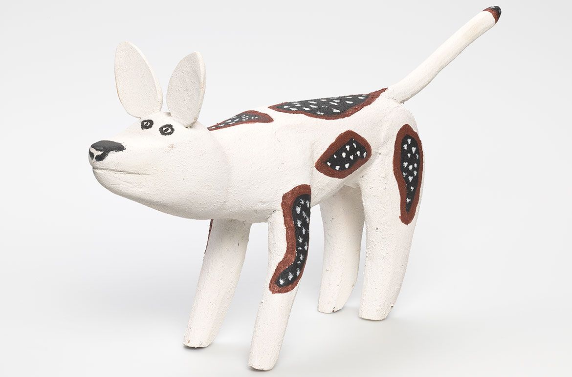 Keith Wikmunea, Wik-Mungkan/Wik-Alkan people, Australia b.1967 / Small ku’ (camp dog) 2010 / Carved milkwood (Alstonia muellerana) with natural pigments, charcoal and acrylic binder / 28 x 48 x 12cm / Purchased 2010 with funds from the Josephine Ulrick and Win Schubert Diversity Foundation through the QAG Foundation / Collection: Queensland Art Gallery| Gallery of Modern Art / © Keith Wikmunea