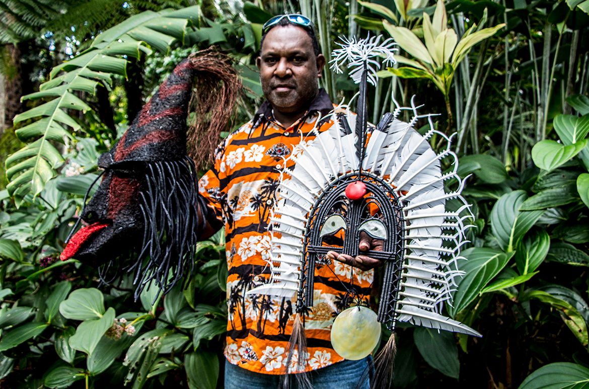 Obery Sambo holding two of his artworks / Photograph: Carli Willis