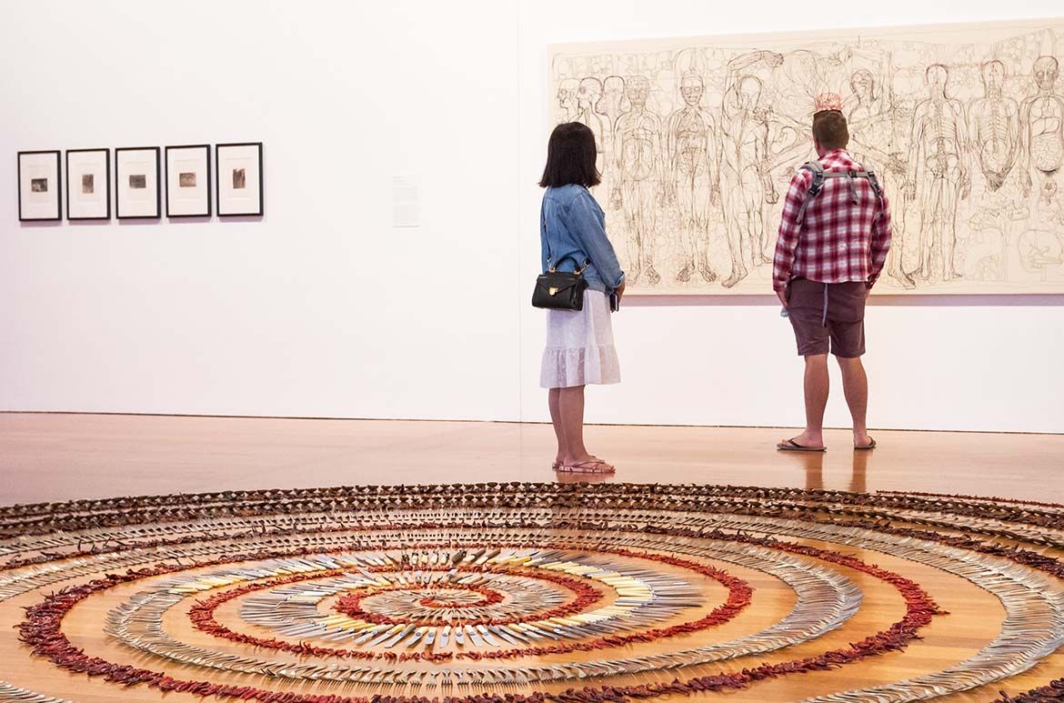 Installation view of Simryn Gill’s Forking tongues 1992 (foreground) / Purchased 2001. Queensland Art Gallery Foundation; five works from Ana Mendieta’s ‘Esculturas Rupestres’ (Rupestrian sculpture) portfolio 1982, printed 1993 (above, left) / Purchased 1996 with a
special allocation from the Queensland Government. Celebrating the Queensland Art Gallery’s Centenary 1895–1995 / © Estate of Ana
Mendieta; and Hermann Nitsch’s Last Supper 1976–79 (above, right) /
Gift of Francesco Conz through the Queensland Art Gallery Foundation
1995 / © Hermann Nitsch/Bildrecht. Licensed by Viscopy, 2018 /
Photograph: Brad Wagner