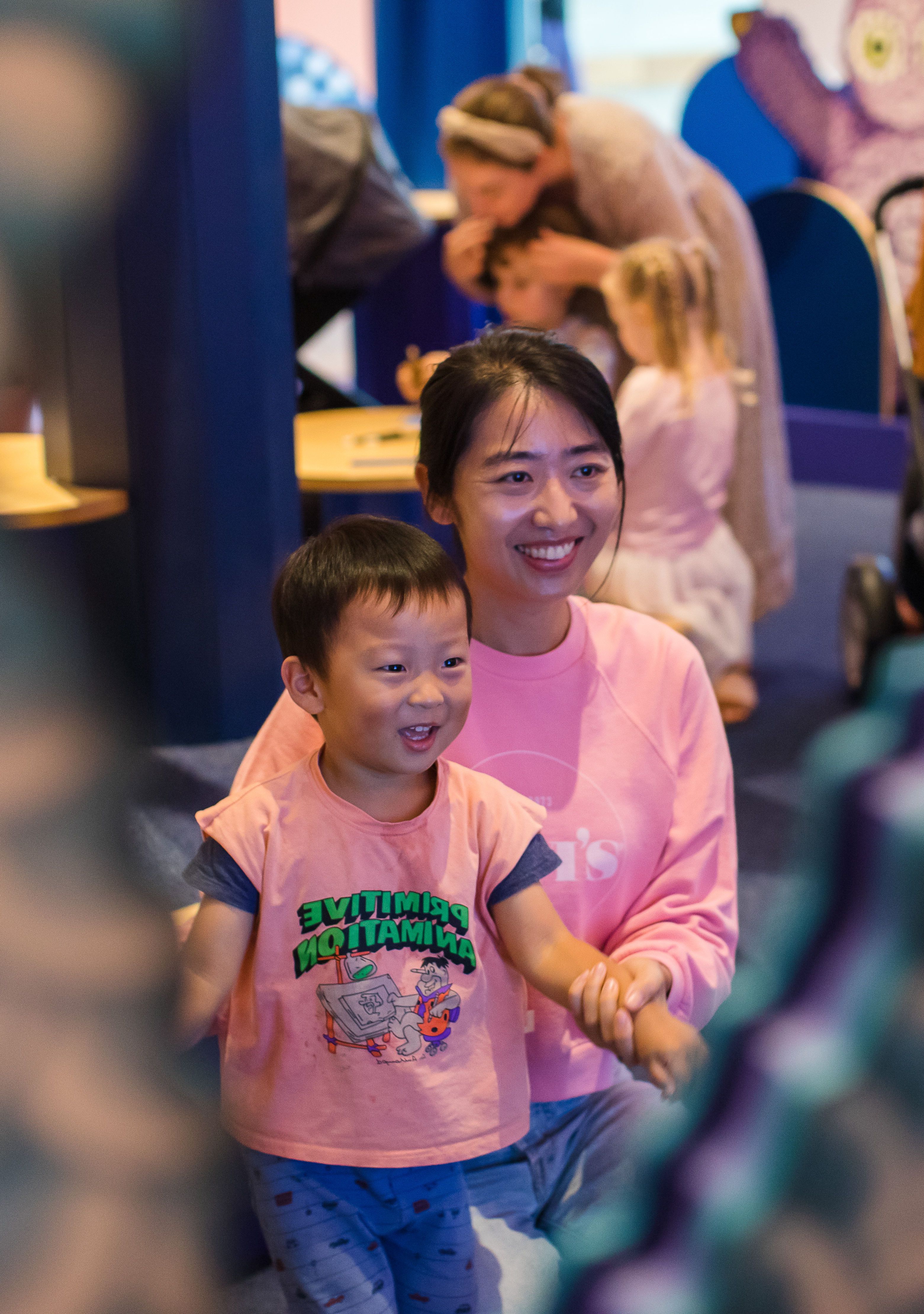 Activity participants watching Vipoo Srivilasa's flower bear animations as part of 'Garden of Love', 2021 / Photograph: K Bennett © QAGOMA