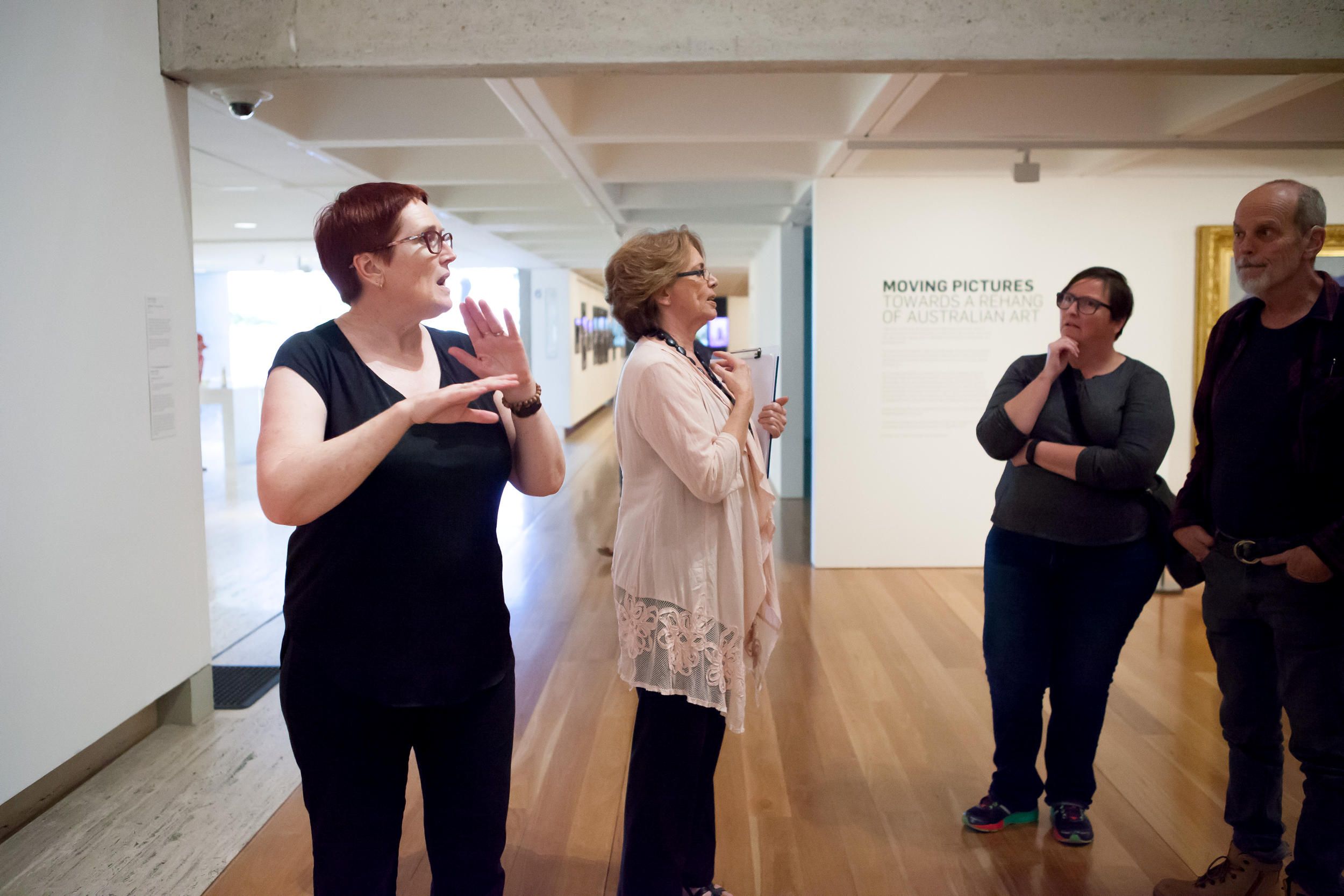 An Auslan interpreter accompanies a volunteer guide on a tour for d/Deaf visitors at the Gallery of Modern Art. Photograph: C. Callistemon