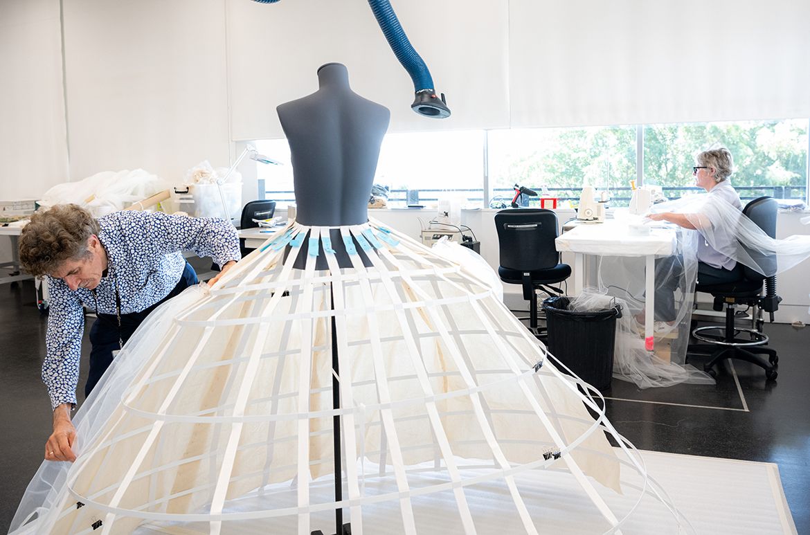 Conservator Michael Marendy preparing the support for the ‘Cream wedding dress’ designed by Eiko Ishioka for Mirror Mirror (2012) installed in ‘Fairy Tales’, Gallery of Modern Art (GOMA), Brisbane 2023 / Photograph: C Callistemon © QAGOMA