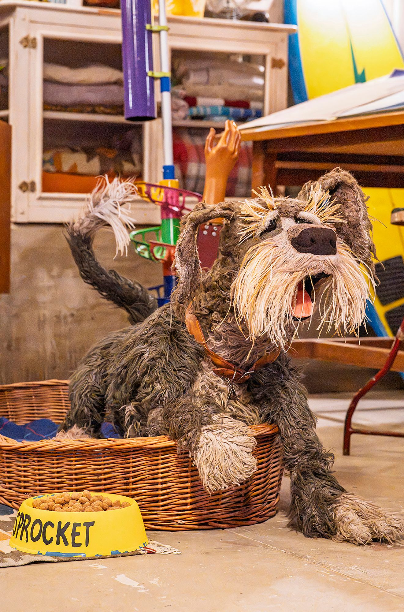 Installation view of 'Make, Believe, Magic: The Worlds of The Jim Henson Company', Gallery of Modern Art (GOMA), Brisbane, 2026, featuring ‘Sprocket the Dog’ puppet with dog bowl from Fraggle Rock: Back to the Rock 2022–present, originally built for Fraggle Rock 1983 / Collection: The Jim Henson Company / © The Jim Henson Company. All Rights Reserved / Photograph: N Umek © QAGOMA