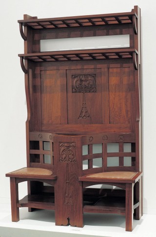 John Merten, Cabinetmaker, Australia 1861-1935; L.J. Harvey, Carver, Australia 1871-1949 / Hallstand 1920s / Black bean (Castanospermum australe) assembled and carved with leather seat and copper drip tray / hallstand: 198 x 115 x 56cm; drip tray: 4.4 x 40.5 x 30.7cm / Gift of Janet and Jack Grace through the Queensland Art Gallery Foundation 2003. Donated through the Australian Government’s Cultural Gifts Program / Collection: Queensland Art Gallery | Gallery of Modern Art / © Estate of the artists
