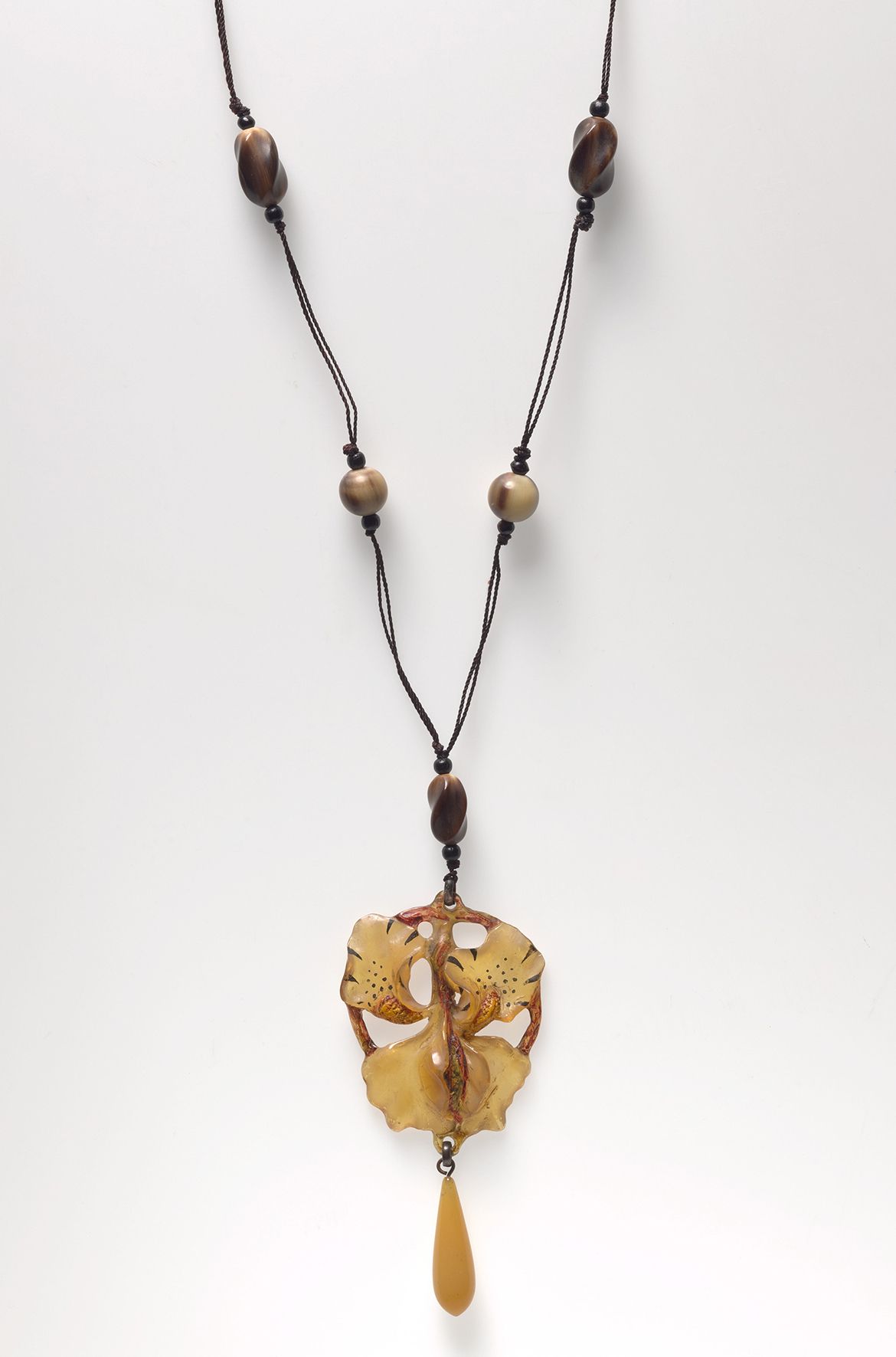 attrib. to Georges Pierre, France 1873–1943 (or Elisabeth Bonté, France dates unknown) / Orchid pendant necklace c.1900 / Horn, yellow glass, silk chord / 50cm (length); 10.5 x 5.5cm (pendant) / Purchased 2021 with funds from the Henry and Amanda Bartlett Trust through the QAGOMA Foundation / Collection: Queensland Art Gallery | Gallery of Modern Art 