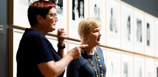A volunteer guide is accompanied by an Auslan interpreter on a tour for d/Deaf visitors at the Queensland Art Gallery. Photograph: M. Pricop 