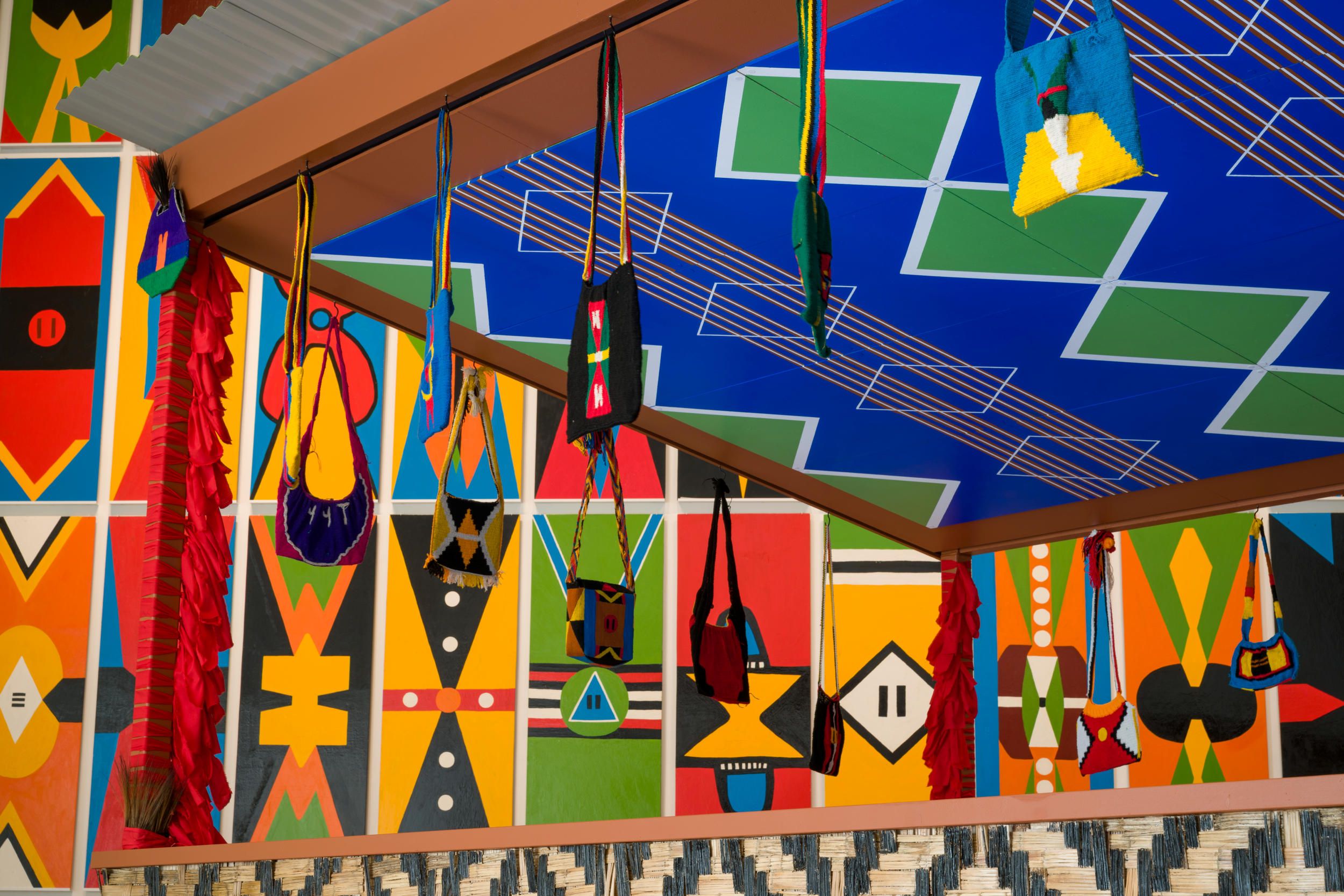 Views of works by Haus Yuriyal, including Kuman (shield) paintings 2024, Kamkau Ike (Haus toktok) 2024 and Yuri Alai Eagles (ceiling shield paintings) 2024, installed for the 11th Asia Pacific Triennial, QAG, 2023 / © The artists / Photograph: C Callistemon, QAGOMA