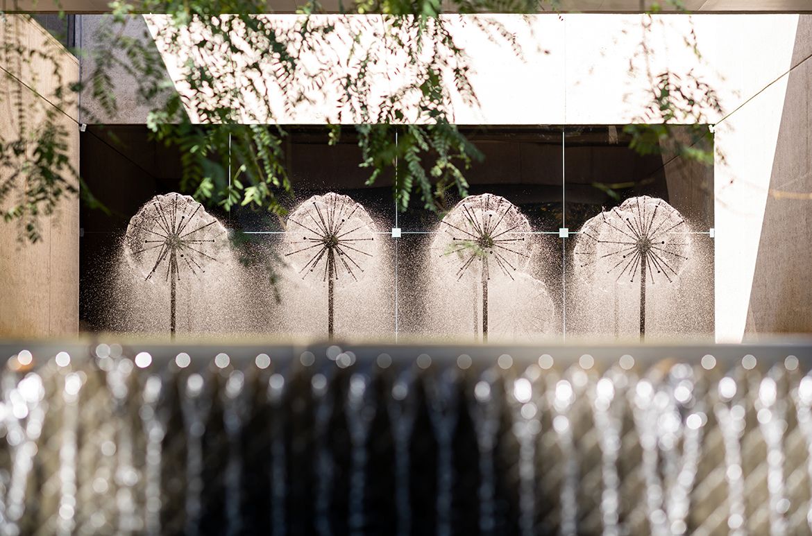 Robert Woodward, Australia 1923–2010 / Dandelion Fountains 1982 viewed from the Queensland Art Gallery Sculpture Courtyard reflection pond and waterfall adjoining the QAG Cafe / 9 bronze fountains with brass pipes / Collection: ArtsWorks Queensland / © Robert Woodward Estate