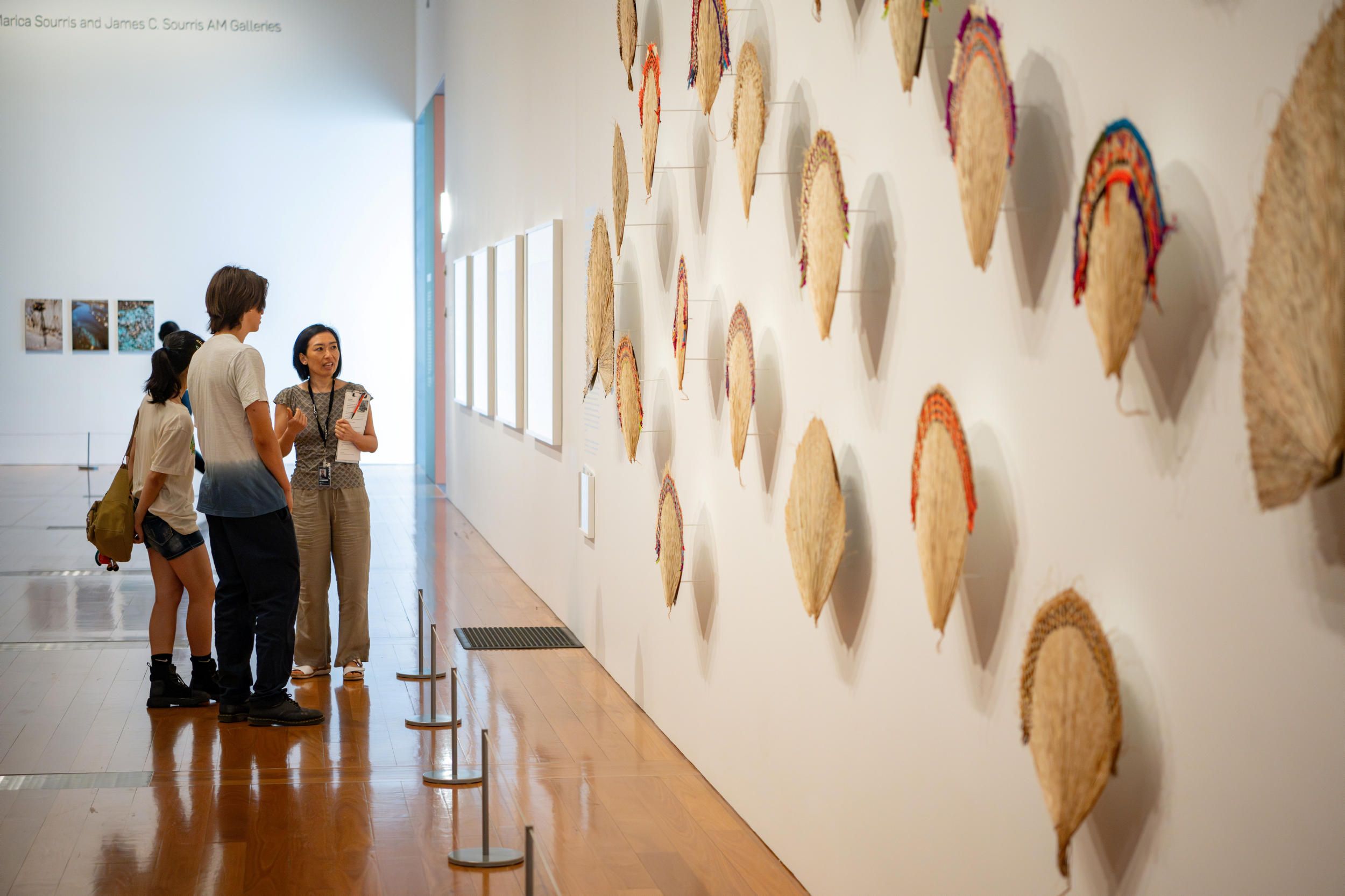 A Volunteer Guide engages visitors on a tour at the Gallery of Modern Art (GOMA). Photography by Nicholas Umek | QAGOMA