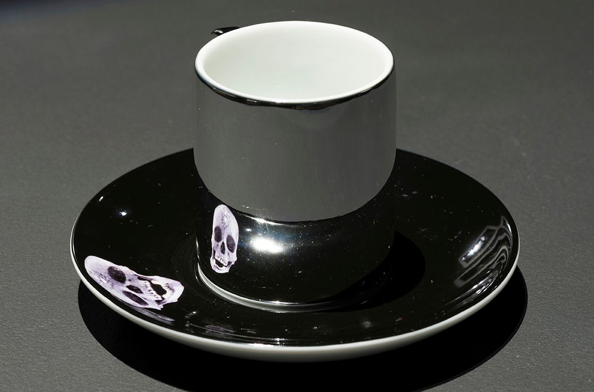 Damien Hirst, United Kingdom b.1965 / For the love of God 2007 / Anamorphic porcelain expresso cup and saucer / Proposed gift of Scott Redford 2022 / Collection: QAGOMA Research Library / © Damien Hirst/DACS/Copyright Agency / Photograph: C Callistemon © QAGOMA