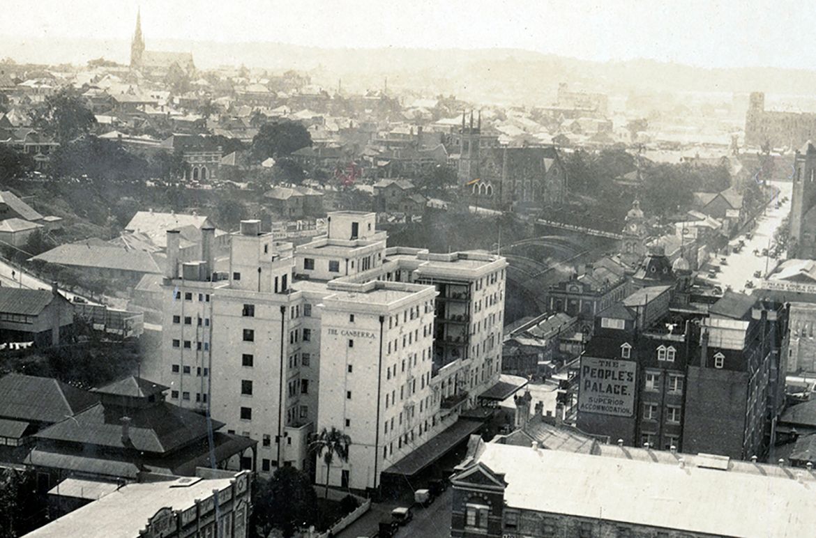 View the city skyline of Brisbane looking toward Central Station Railway, with the Canberra Hotel, Peoples Palace, and Brisbane Fire Brigade Station in the foreground, and St Pauls Presbyterian Church, St Pauls Terrace in the distance, c.1931 / Courtesy: John Oxley Library, State Library of Queensland, Brisbane