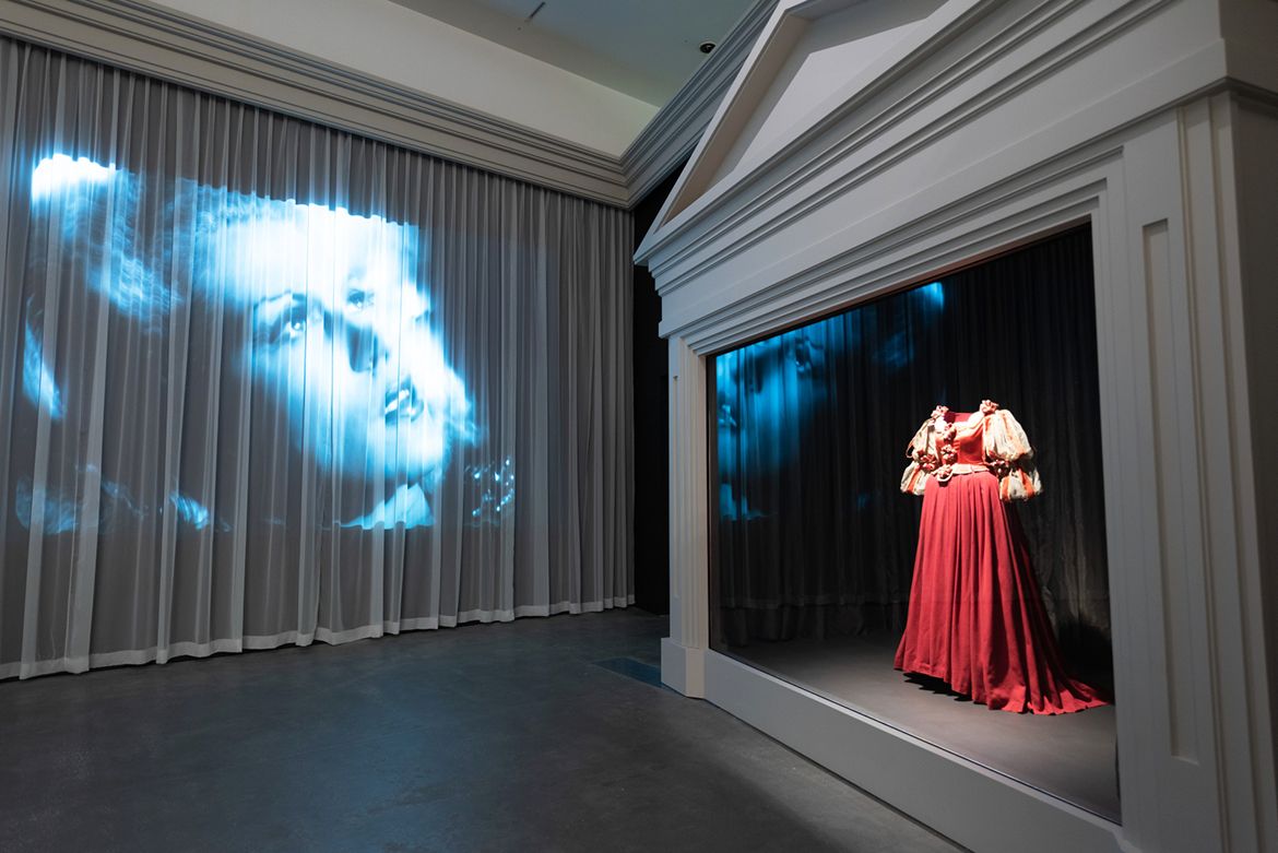 Installation view ‘Fairy Tales’, Gallery of Modern Art (GOMA) Brisbane 2023 / Jean Cocteau (director), France 1889–1963; Film clip from La Belle et la Bête (Beauty and the Beast) 1946; 35mm, black and white, mono, 96 minutes, France, French (English subtitles); Director/script: Jean Cocteau; Cinematographer: Henri Alekan; Editor: Claude Iberia; Cast: Jean Marais, Josette Day; Courtesy: Société nouvelle de distribution (SND), Paris; 1996–98 AccuSoft Inc. All Rights Reserved / Jean Cocteau (director), France 1889–1963; Marcel Escoffier (designer), Monaco 1910–2001; ‘Adélaïde’ costume from La Belle et la Bête (Beauty and the Beast) 1946; Silk satin, wool cheesecloth, velvet, chiffon, straw; Collection: La Cinémathèque française, Paris; © Société nouvelle de distribution (SND); 1996–98 AccuSoft Inc. All Rights Reserved; Photograph: N Umek © QAGOMA