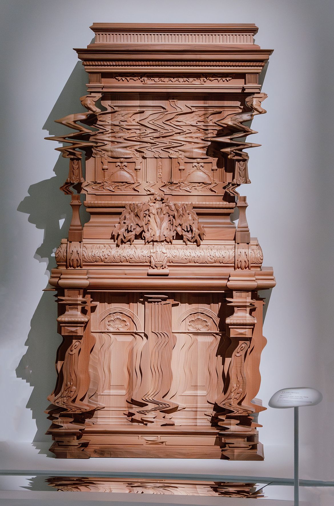 Installation view ‘Iris van Herpen: Sculpting the Senses’, GOMA 2024 featuring Good Vibrations Cabinet 2013 by Ferruccio Laviani / Conceived for Italian furnishing company Fratelli Boffi / Oak and walnut, sculpted, chiselled and engraved using digital processes / Purchased from Fratelli Boffi thanks to the patronage of Cercle Design 20/21/2020 / Collection: Musée des Arts Décoratifs, Paris / © Ferruccio Laviani / Photograph: J Ruckli © QAGOMA