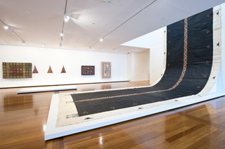 Kulupu Falehanga‘i Teleiloa, New Zealand/Tonga est. 2010 / Ngatu tā’uli 2011 / Koka (pigment from koka tree) and black commercial paint on Hiapo (paper mulberry) barkcloth / 2215 x 420cm / Commissioned 2011. QAG Foundation / Collection: Queensland Art Gallery | Gallery of Modern Art / © The artists