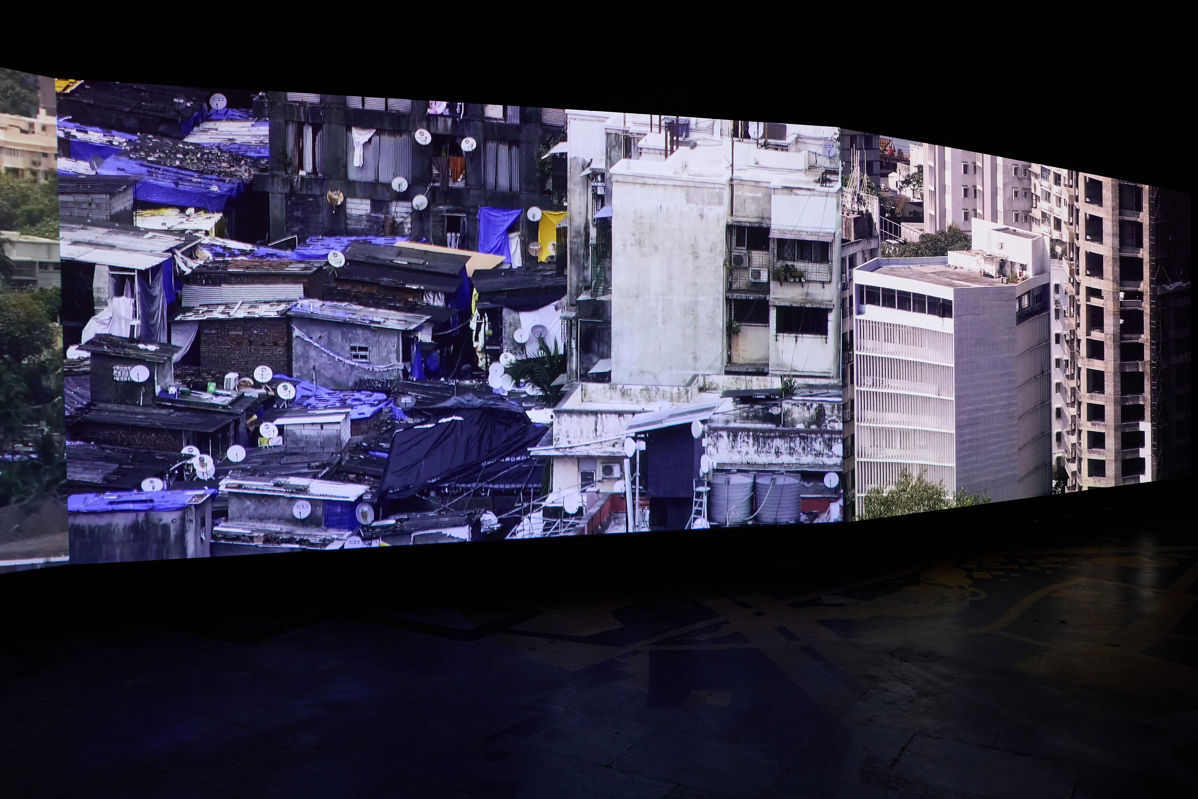 CAMP / Mumbai, India, est.2007 / Bombay Tilts Down 2022 / Seven-channel environment with music, 13 min 14 sec (looped). Filmed by CCTV camera from a single-point location in South-Central Mumbai / 13:14 minutes