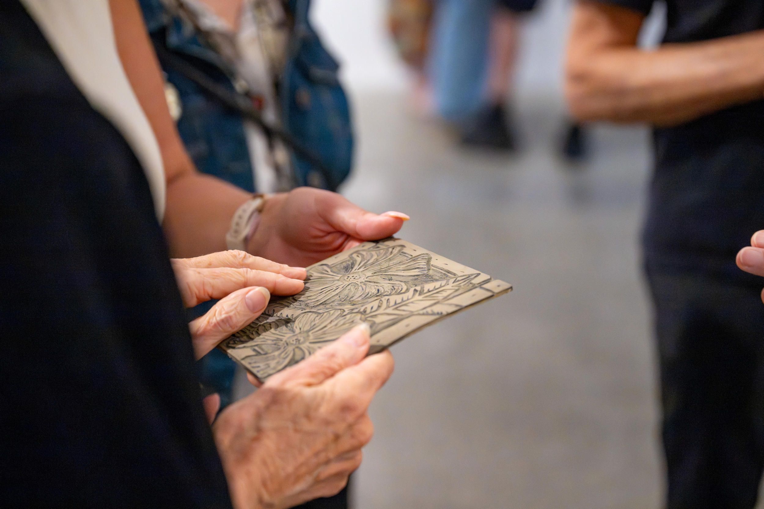 Visitor enjoying tactile element on a guided tour at GOMA | Photograph: N Umek