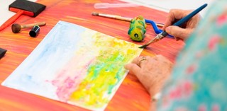 Art and Dementia program participants engage in creative making activity / Photograph: C Callistemon / © QAGOMA