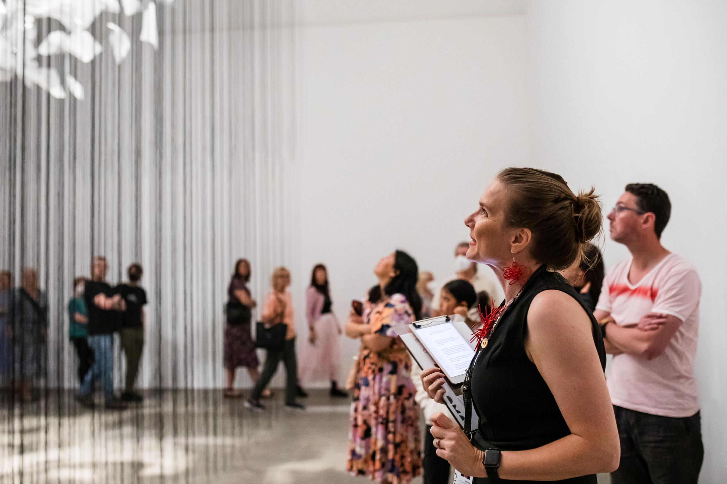 A Volunteer Guide engages visitors on a tour at the Gallery Modern Art. Photography by Katie Bennett | QAGOMA