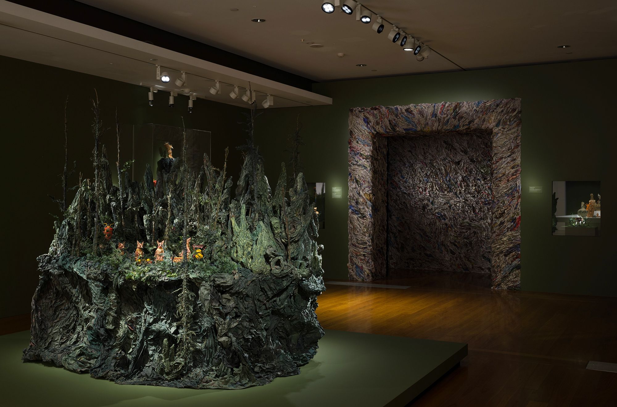 Zhang Xu Zhan, Taiwan b.1988 / Compound eyes of tropical 2020–22/2024, installation view ‘The 11th Asia Pacific Triennial of Contemporary Art’ 2024 / Single-channel 4K video installation: colour, sound, 16 minutes, ed. 6/6; wire, newspaper, glazed paper, paste, plastic beads, accessories / 5 puppets: 5 bases / Lakeview Square – Gamelan Band 2021–22 / Wire, newspaper, glazed paper, paste, plastic beads, accessories / Purchased 2024. QAGOMA Foundation / Collection: Queensland Art Gallery | Gallery of Modern Art / © Zhang Xu Zhan / Photograph: C Callistemon © QAGOMA
