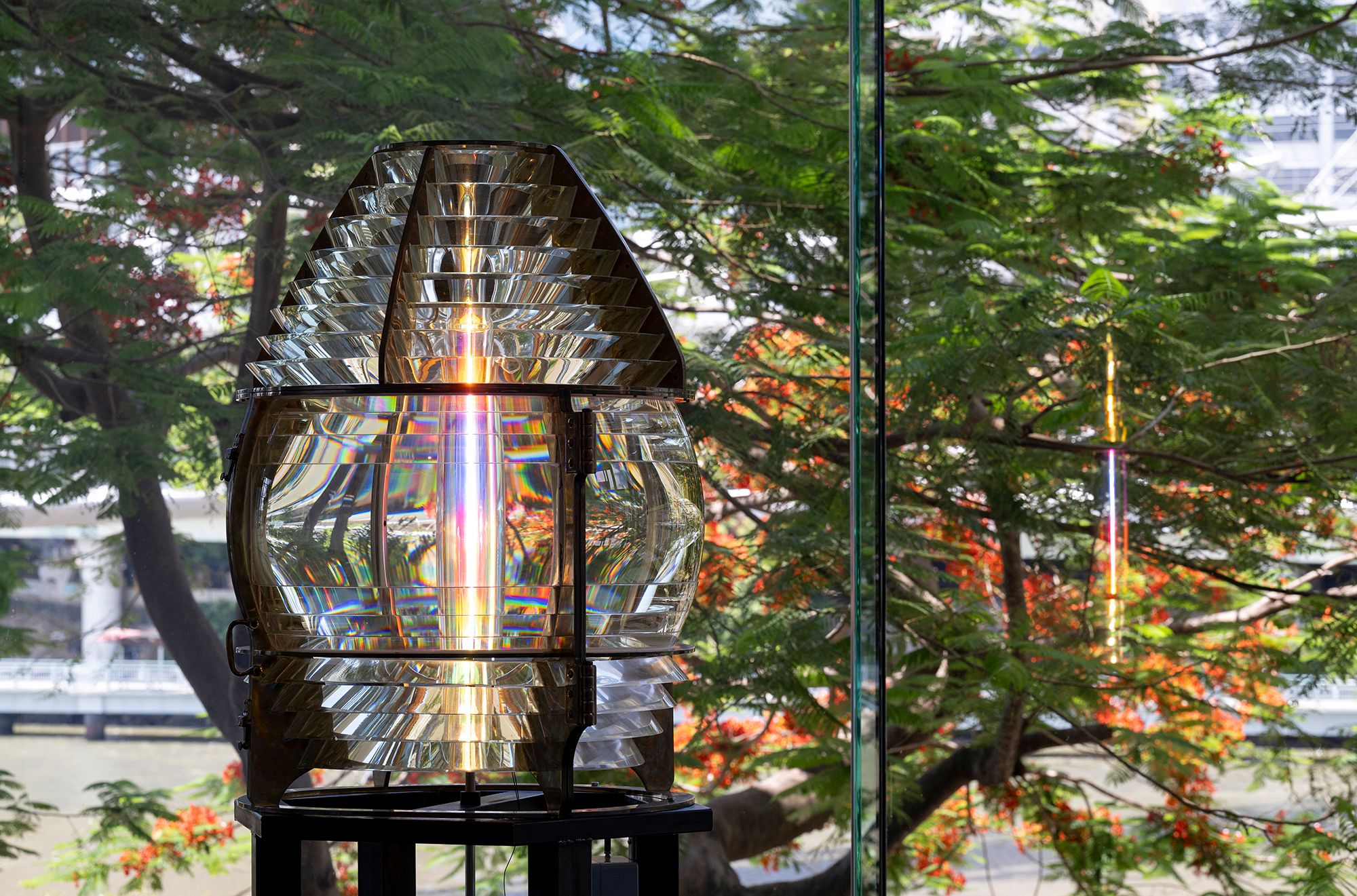 Olafur Eliasson, Denmark b.1967 / Your lost lighthouse (Installation view, Gallery of Modern Art, Brisbane) 2020 / Lighthouse lens (c.1900), colour-effect filter cylinder, halogen light bulb, fluorescent light, brass, steel, ballast 217 x 96 x 96cm / © 2020 Olafur Eliasson / Courtesy: The artist; neugerriemschneider, Berlin; and Tanya Bonakdar Gallery, New York / Photograph: C Callistemon © QAGOMA