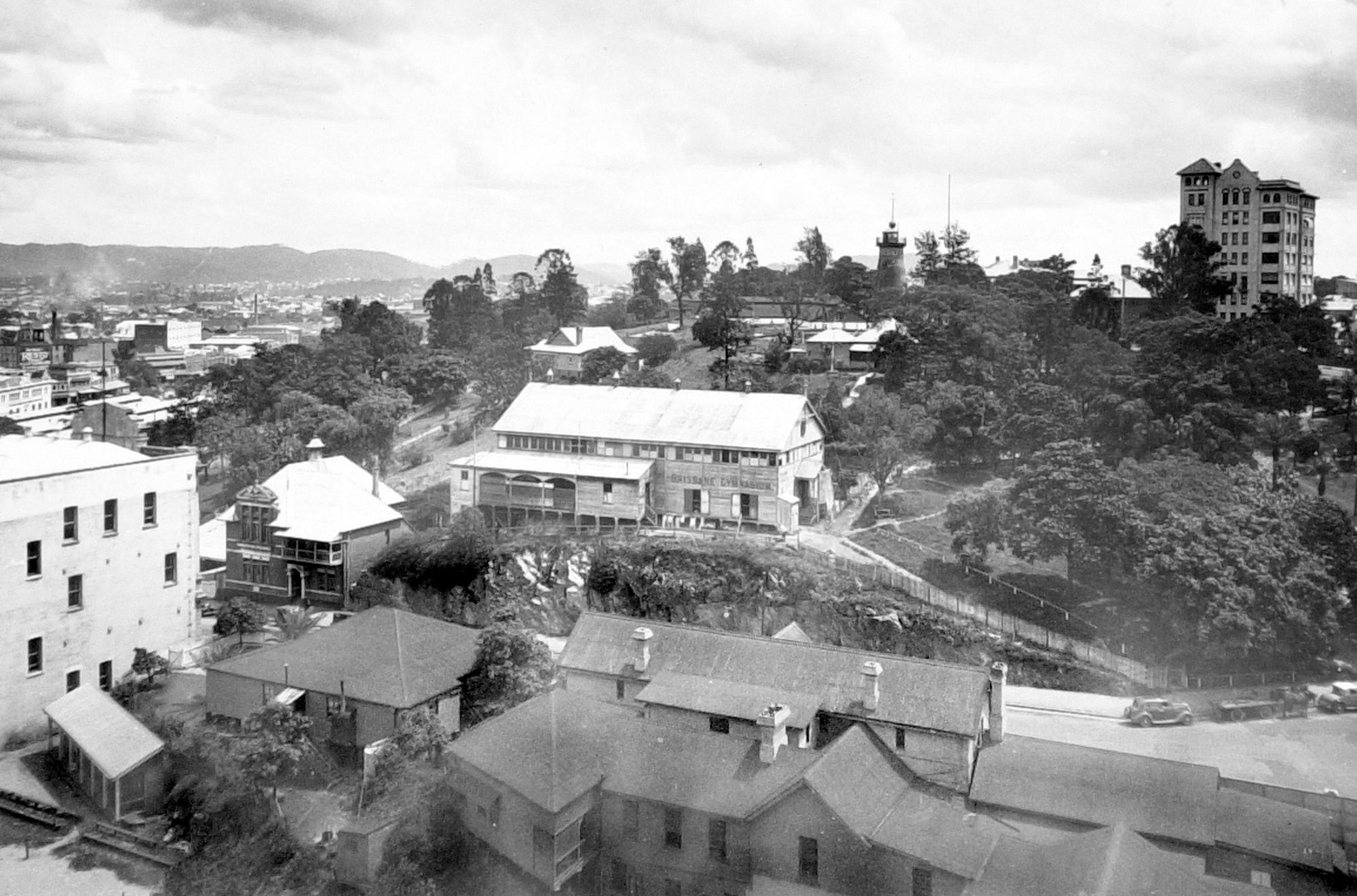 Looking from the corner of Ann and Edwards Streets over the Trades Hall building towards the YMCA Sailors Department, Brisbane Gymnasium, with the Observatory and Craigston apartments in the background, 1933 / ITM1009387 /Courtesy: Queensland State Archives