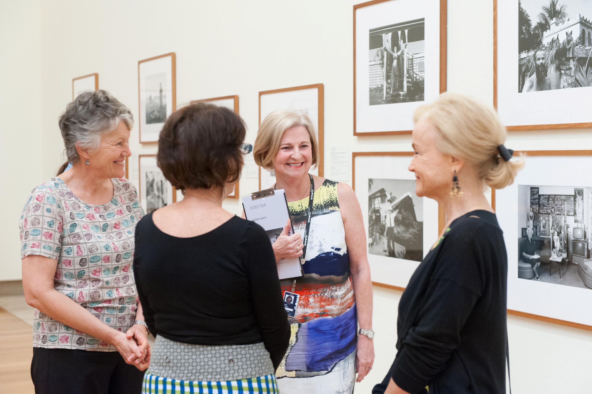 A Volunteer Guide engages visitors on a tour at the Queensland Art Gallery | Installation View | Photography by M. Sherwood | © QAGOMA