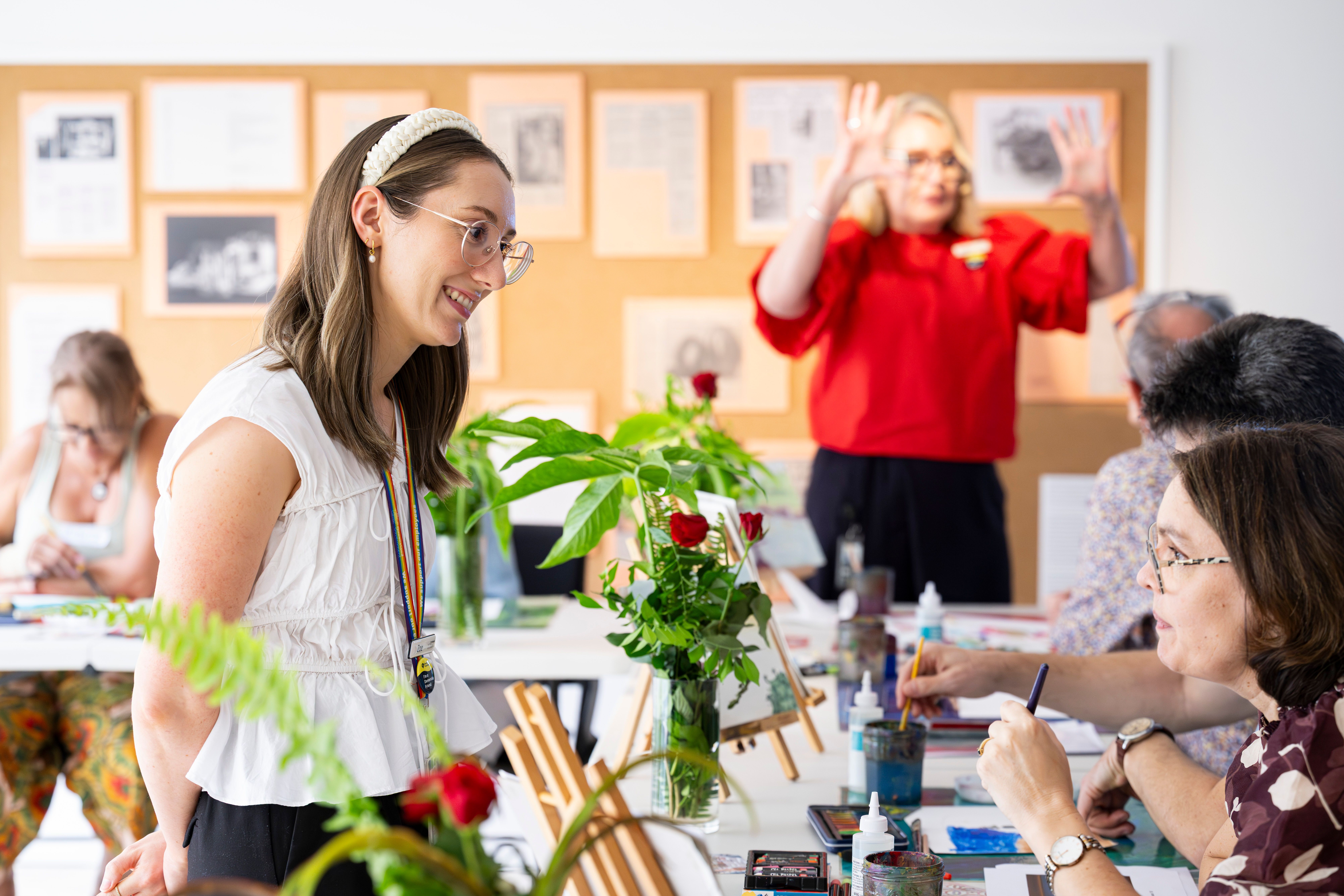 Program facilitators and participants engaging in creative making activity / Photograph: C Callistemon / © QAGOMA