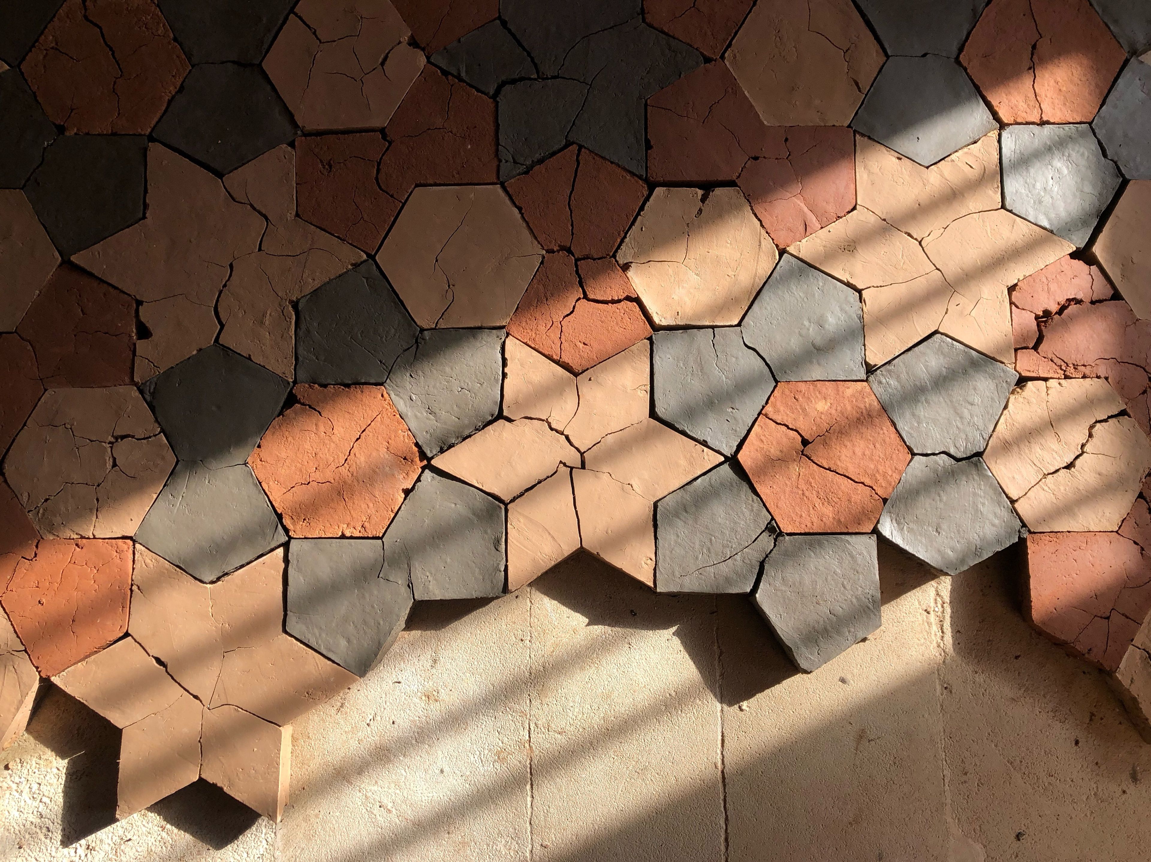 Dana Awartani / Jeddah, Saudi Arabia, b.1988 / Standing by the ruins 2022 / Compressed earth and pigment / 850 x 310cm (approx.) 850 x 310cm (439 adobe bricks) / Purchased 2024 with funds from the Contemporary Patrons through the Queensland Art Gallery | Gallery of Modern Art Foundation / Purchased 2024 with funds from the Contemporary Patrons through the Queensland Art Gallery | Gallery of Modern Art Foundation / Courtesy: The artist / © Dana AWARTANI / Photograph: / Image courtesy: The artist