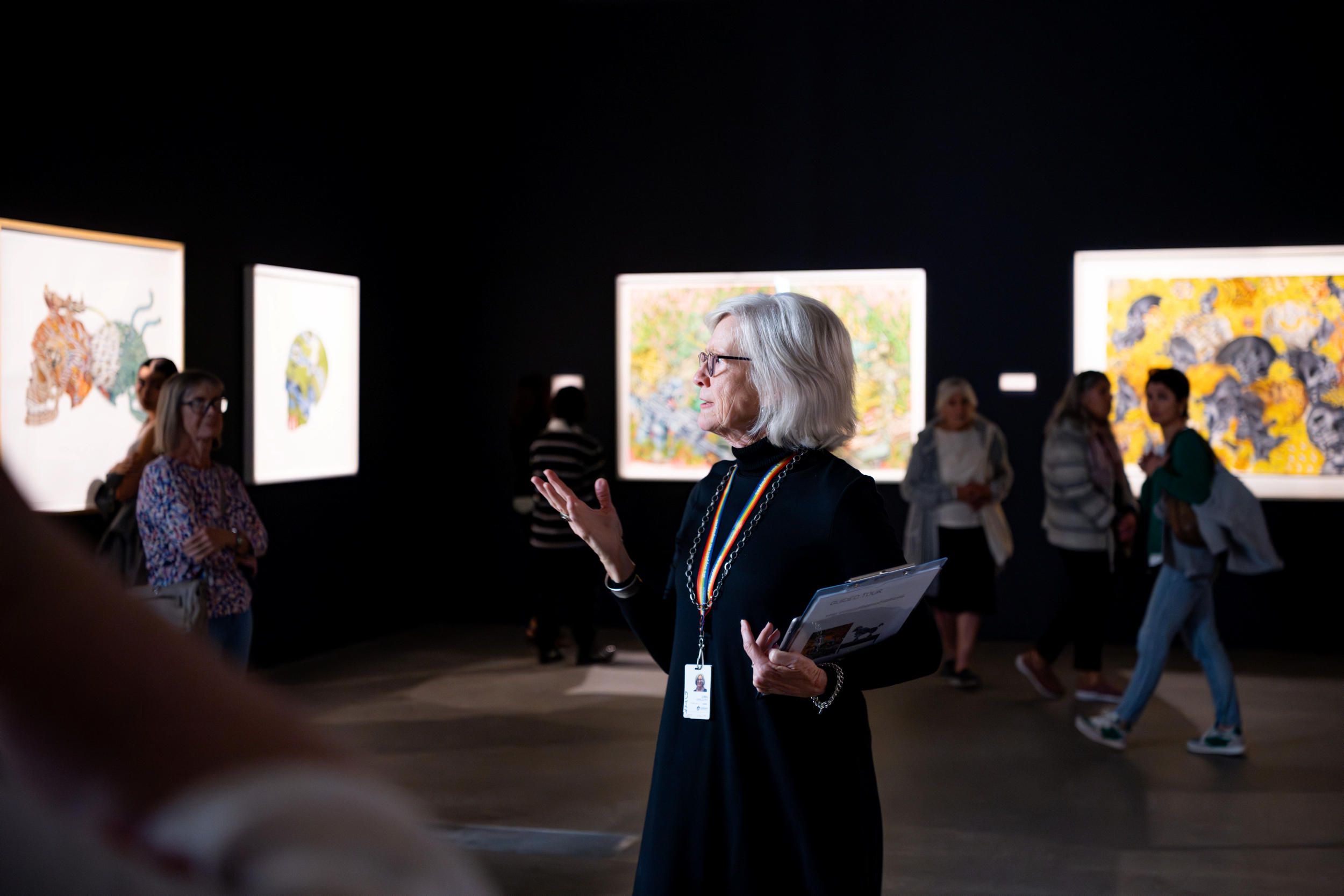 A Volunteer Guide engages visitors on a tour at the Gallery of Modern Art. Photography by Chloe Callistemon | QAGOMA