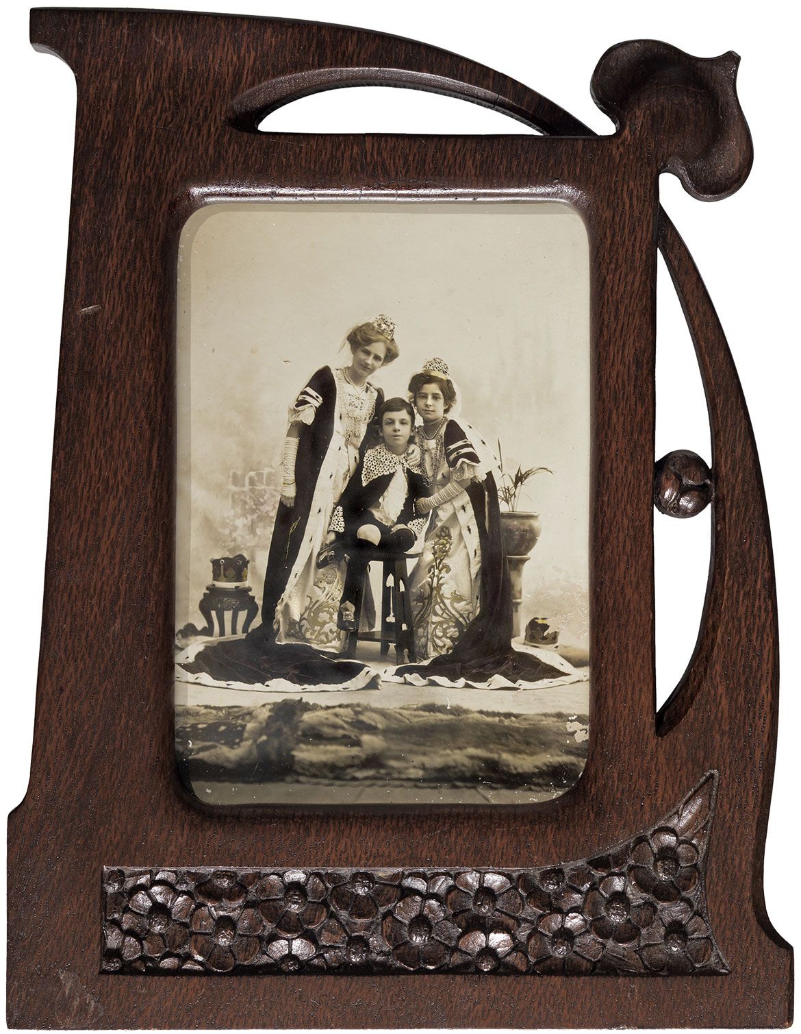 L.J Harvey, Australia 1871-1949 / Elise, Thelma and George Harvey dressed for the coronation pageant 1911. Costumes designed by RG Rivers c.1910-15 / Photograph in carved silky oak Art Nouveau frame / 32 x 25.6cm / Gift of the Reverends David and Bruce Noble in memory of their mother Elsie Harvey Noble through the Queensland Art Gallery Foundation 2008 / Collection: Queensland Art Gallery | Gallery of Modern Art