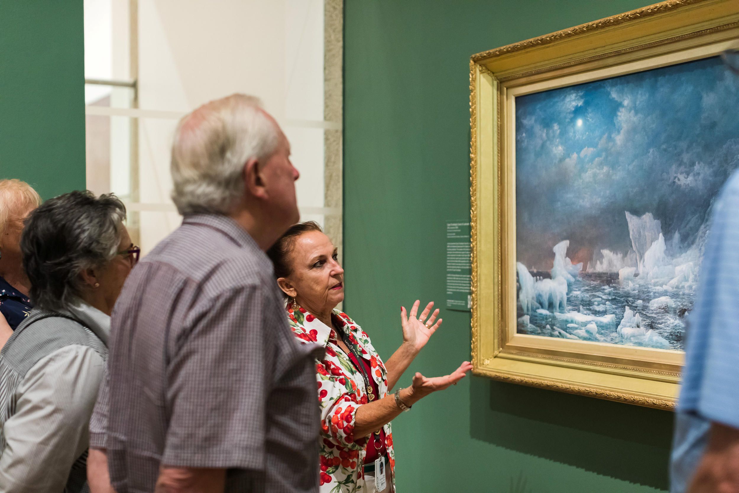 A Volunteer Guide engages visitors on a tour at the Queensland Art Gallery. Photography by Katie Bennett | QAGOMA