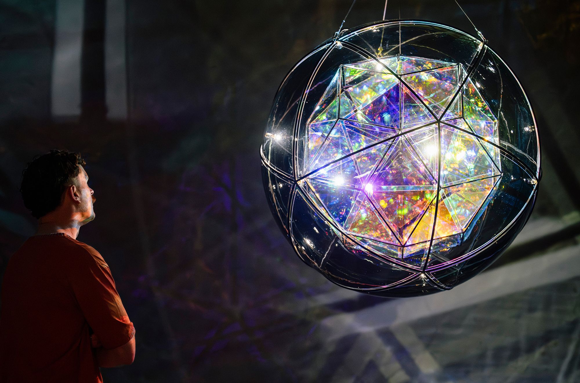 Olafur Eliasson, Denmark b.1967 / Firefly city 2025 / Coloured glass (purple), coloured glass (clear) with semi-transparent mirror colour-effect filter, colour-effect filter glass (blue, red), LEDs, aluminium, stainless steel, paint (black), wire, motor, ballast / 103cm (diam.) / © 2025 Olafur Eliasson / Courtesy: The artist; neugerriemschneider, Berlin; Tanya Bonakdar Gallery, New York / Photograph: J Ruckli © QAGOMA