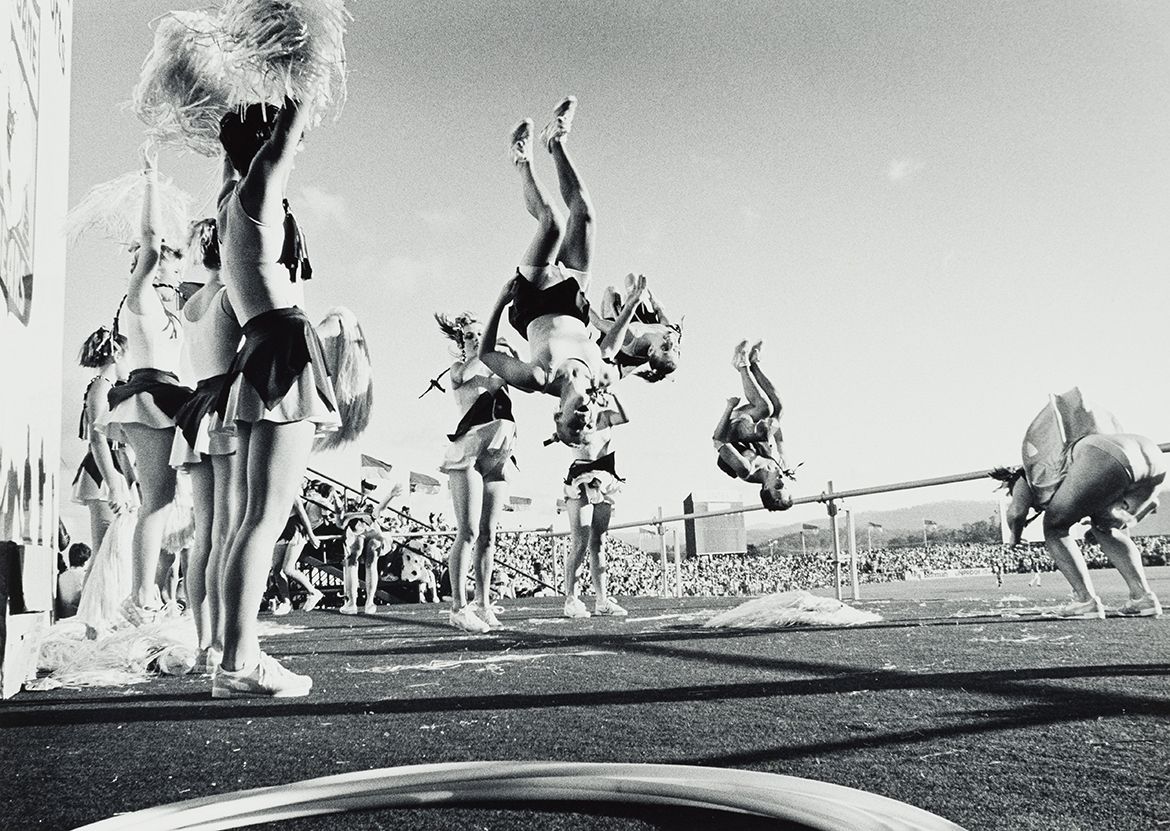 Graham Burstow, Australia 1927-2022 / Cheer squad, Carrara (from ‘Journeys North’ portfolio) 1986-87 / Gelatin silver photograph / 34 x 47.7cm (comp.) / Purchased 1987 with the financial assistance of the Australian Bicentennial Authority to commemorate Australia’s Bicentenary in 1988 / Collection: Queensland Art Gallery | Gallery of Modern Art / © Estate of Graham Burstow