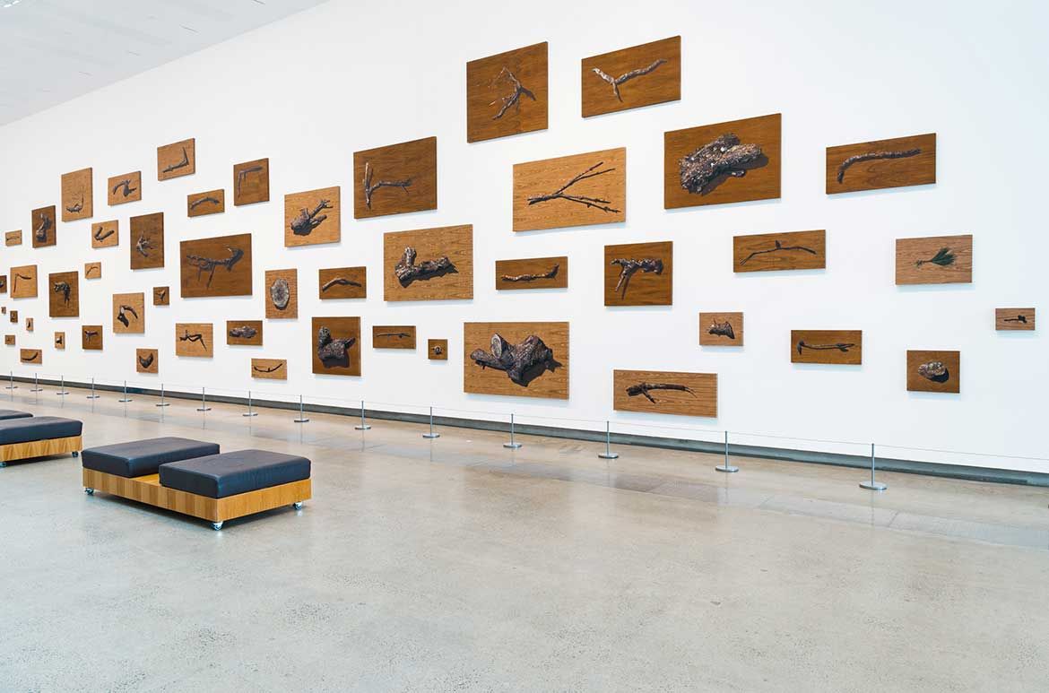 Nona Garcia, The Philippines b.1978 / Untitled Pine Tree 2018, installed at APT9, GOMA / Oil on wood veneer / 50 panels: from 30 x 35cm to 122 x 244cm (each, approx.) / © Nona Garcia