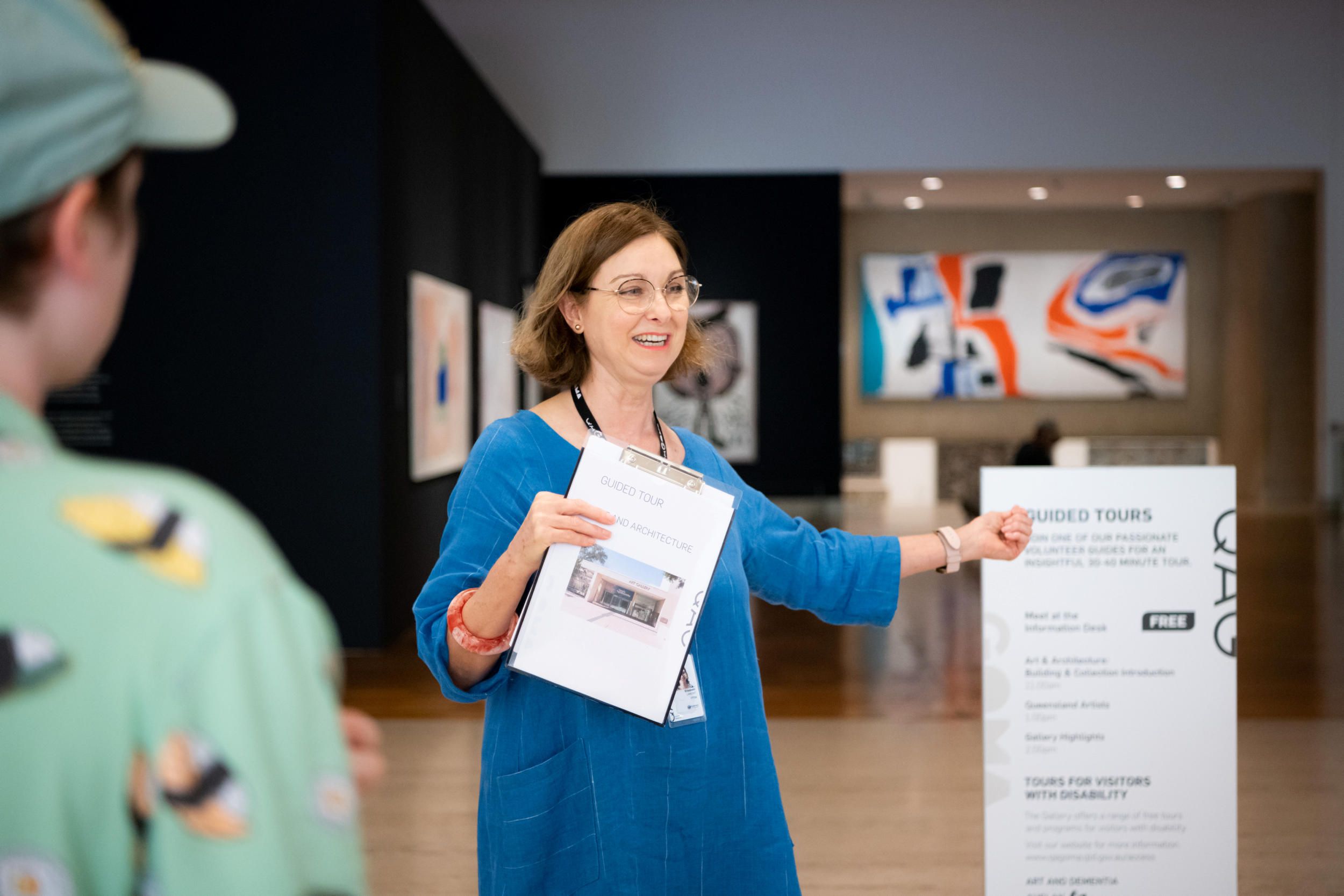 A Volunteer Guide leads visitors on a tour at the Queensland Art Gallery. Photography: Chloe Callistemon | QAGOMA