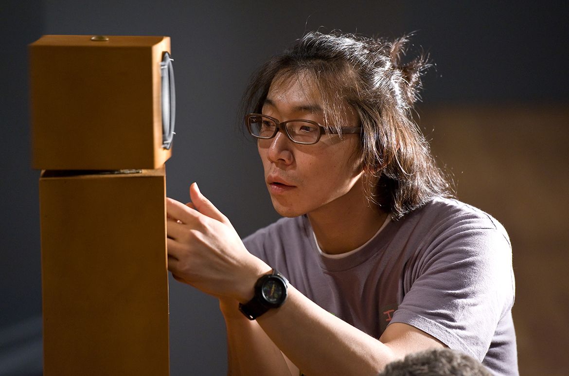 Hiraki Sawa installing the revolving speakers for O in 2009, commissioned for ‘The 6th Asia Pacific Triennial of Contemporary Art’ (APT6)