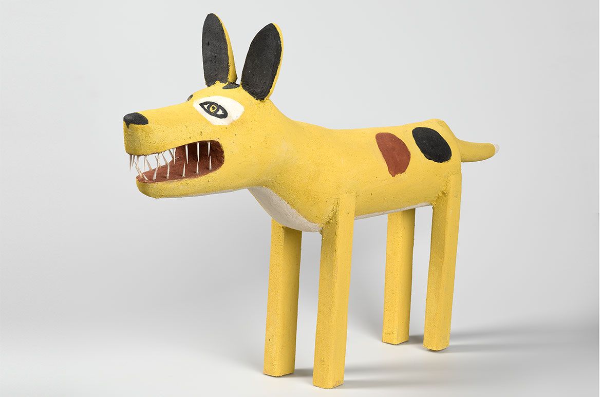 Garry Namponan, Wik-Alkan/Wik-Ngatharr people, Queensland, Australia b.1960 / Yellow-patched camp dog 2006 / Carved milkwood with natural pigments and synthetic polymer paint / 86 x 50 x 30cm / Purchased 2007. QAG Foundation / Collection: Queensland Art Gallery | Gallery of Modern Art / © Garry Namponan