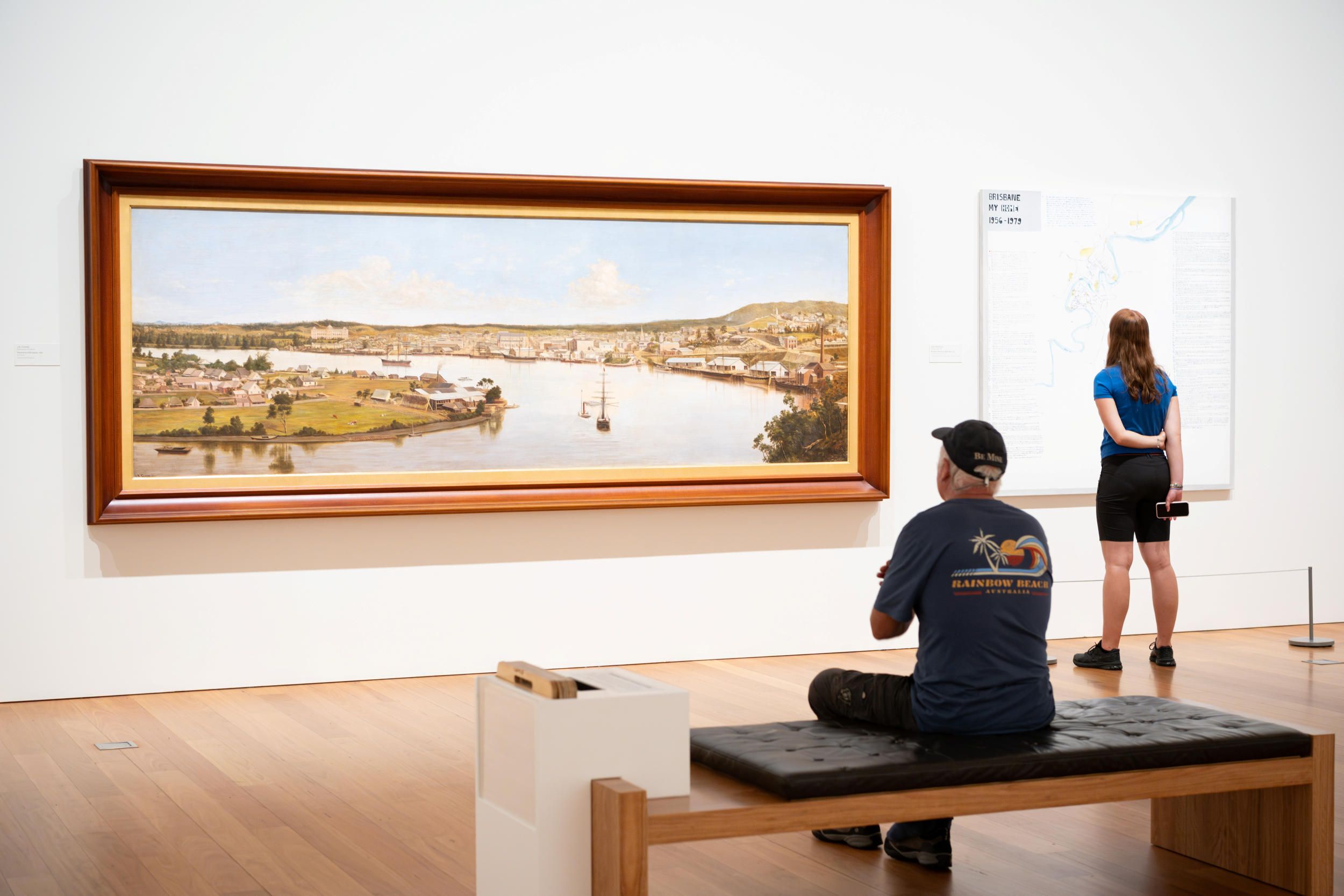 Left: J.A. Clarke / England/Australia 1840–90 / Panorama of Brisbane (installation view) 1880 / Oil on canvas / 137.1 x 365.7cm / Collection: Queensland Museum

Right: Noel Mckenna / Australia QLD b.1956 / Brisbane: My Home 1956-1979 (installation view) 2014 / Synthetic polymer paint on canvas / 160 x 160cm160 x 160 cm / Purchased 2014. Queensland Art Gallery | Gallery of Modern Art Foundation / Collection: Queensland Art Gallery | Gallery of Modern Art / © Noel McKenna/Copyright Agency