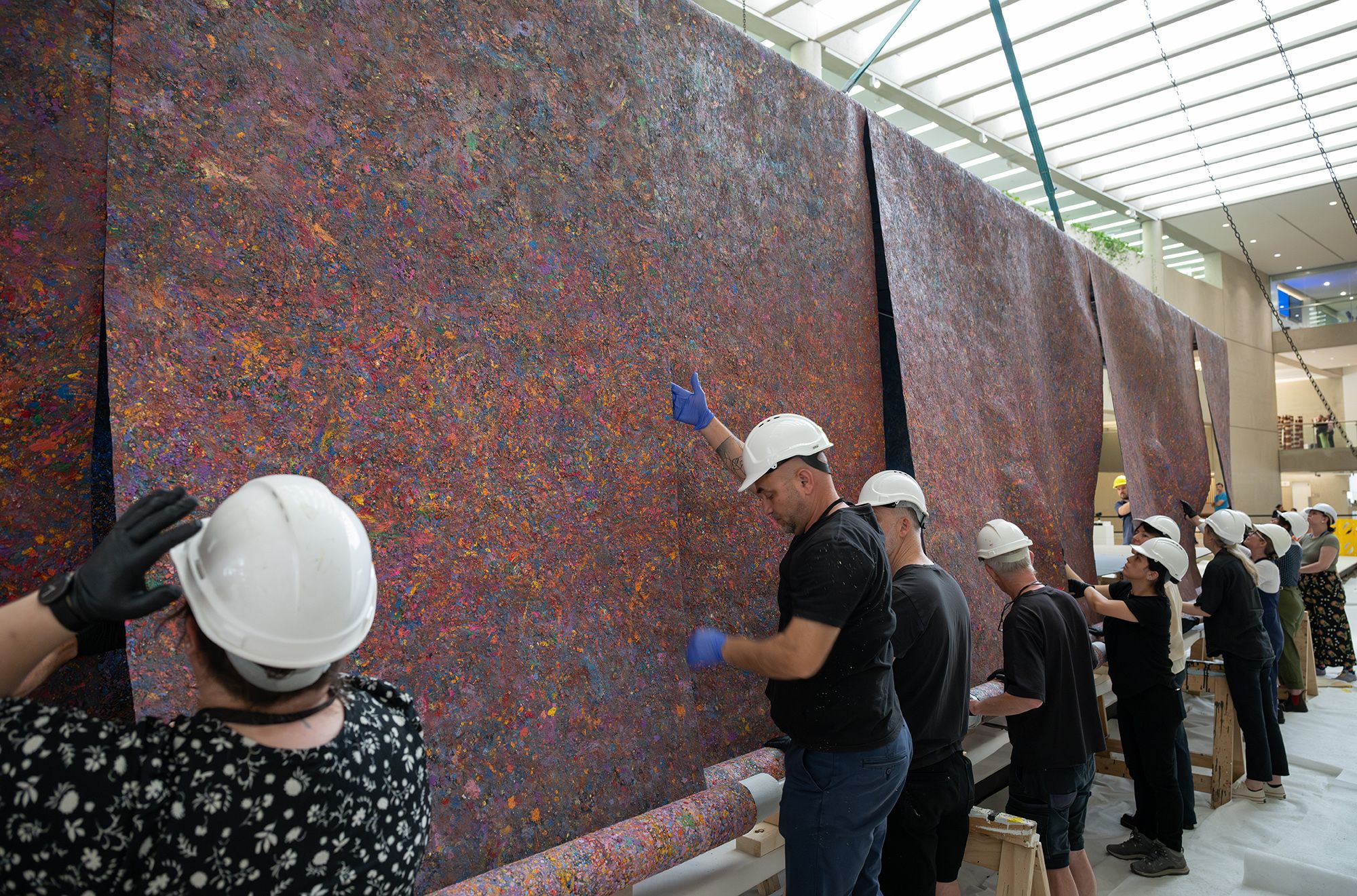 Mit Jai Inn, Thailand b.1960 / Installation of Untitled (Tunnel #APT) 2024 / Oil on canvas / Eight parts: 150 × 1200cm (each, approx.) / Site specific work commissioned for ‘The 11th Asia Pacific Triennial of Contemporary Art’, Queensland Art Gallery Watermall, 2024 / © Mit Jai Inn / Courtesy: The artist and Silverlens, Manila and New York / Photograph: N Umek © QAGOMA