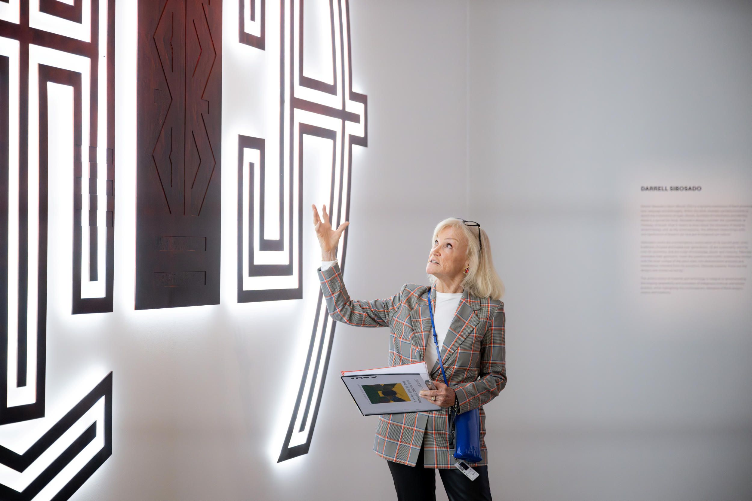 Volunteer Guide talking to Darrell Sibosado's artwork 'Ilgarr (blood)' at the Gallery of Modern Art.

Photography: Chloe Callistemon


Darrell SIBOSADO b.1966 Bard people Australia WA Ilgarr (blood) 2024 Multi-piece enamelled steel with incorporated LED backlighting 300 x 760cm (installed, approx.) 2024.426a- Commissioned for APT11. Purchased 2024 with funds from the Contemporary Patrons through the Queensland Art Gallery | Gallery of Modern Art Foundation



