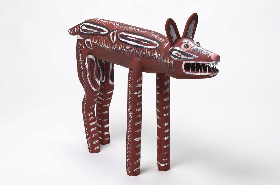 Craig Koomeeta, Wik-Alkan people, Australia b.1977 / Ku’ (Camp dog) 2010 / Carved milkwood (Alstonia muellerana) with synthetic polymer paint and glass marbles / 57 x 79 x 16cm / Purchased 2010 with funds from the Josephine Ulrick and Win Schubert Diversity Foundation through the QAG Foundation / Collection: Queensland Art Gallery | Gallery of Modern Art / © Craig Koomeeta