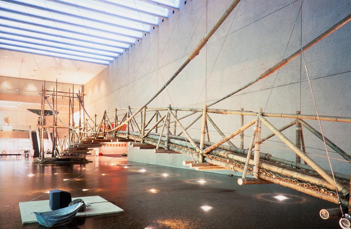 Cai Guo-Qiang, China b.1957 / Bridge Crossing 1999 / Bamboo, rope, rainmaking device, aluminum boat, and laser sensors / Site specific work commissioned 1999 for ‘The 3rd Asia Pacific Triennial of Contemporary Art’ (APT3) / Courtesy: Cai Guo-Qiang