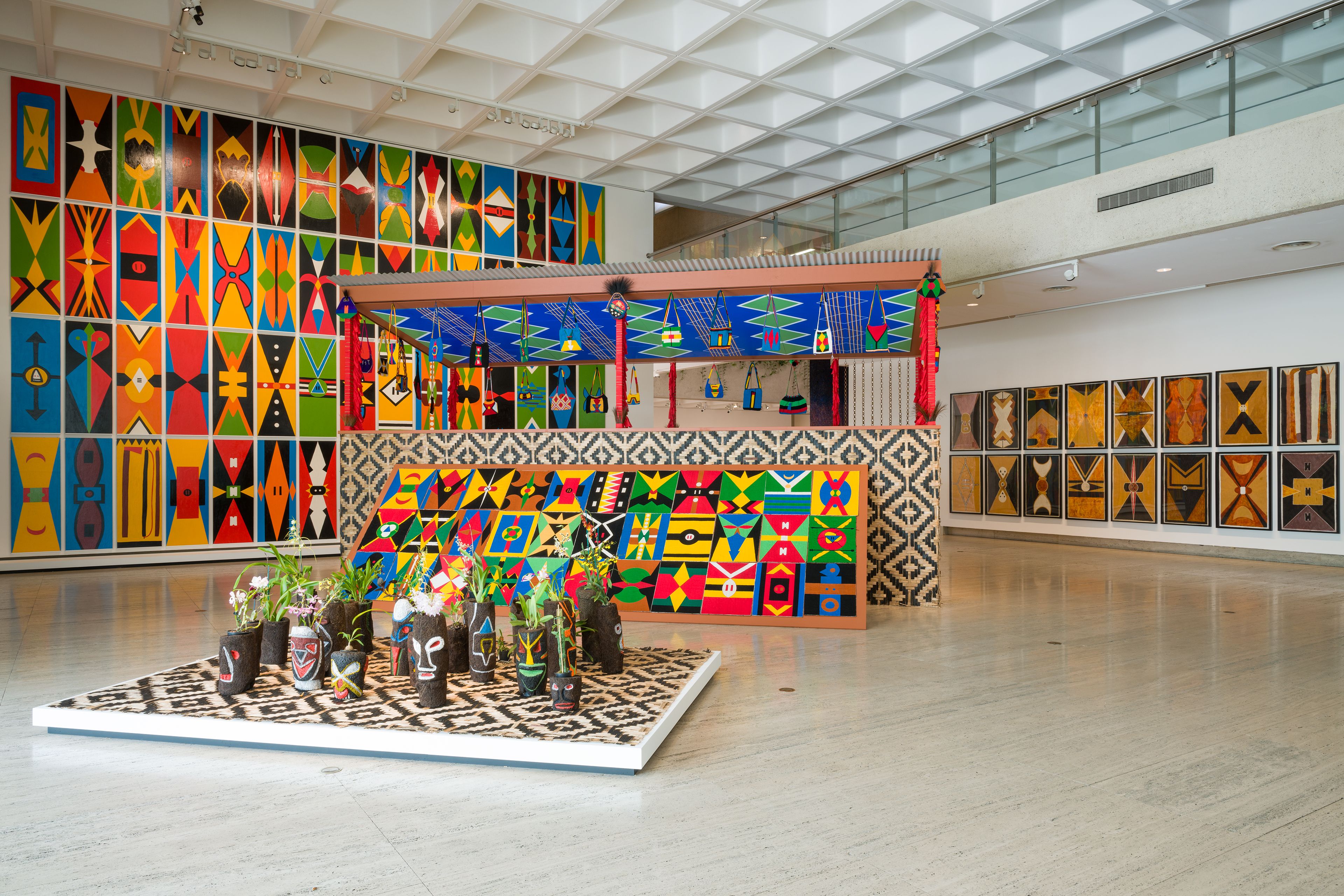 Views of works by Haus Yuriyal, including Kuman (shield) paintings 2024, Bopa 2024, Kalabus 2024, Kamkau Ike (Haus toktok) 2024, Yuri Alai Eagles (ceiling shield paintings) 2024 and Garpa (ground) paintings 2023, installed for the 11th Asia Pacific Triennial, QAG, 2023 / © The artists / Photograph: C Callistemon, QAGOMA