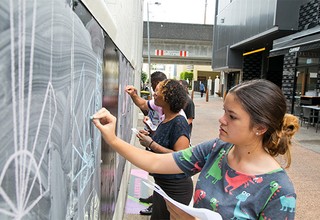 Mackenzie Lee and her fellow Design Track creatives combining, testing and refining logos on the Fish Lane chalkboard. Photography by David Williams, Gilimbaa