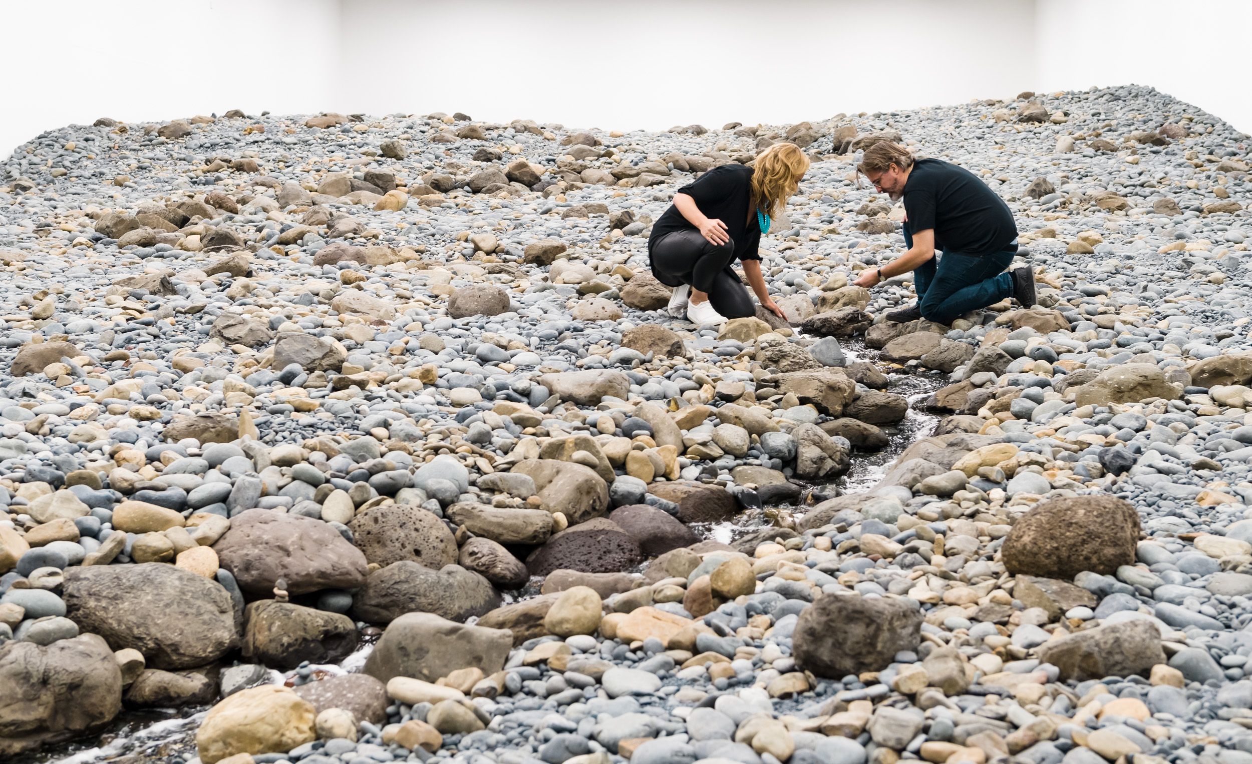 (l-r) Geraldine Kirrihi Barlow and Olafur Eliasson viewing Riverbed 2014 (installation view, GOMA, 2019) / Water, rock (volcanic stones [blue basalt, basalt, lava], other stones, gravel, sand), wood, steel, plastic sheeting, hose, pumps / Purchased 2021. The Josephine Ulrick and Win Schubert Charitable Trust Collection: The Josephine Ulrick and Win Schubert Charitable Trust, QAGOMA / Collection: Queensland Art Gallery | Gallery of Modern Art / © 2014 Olafur Eliasson