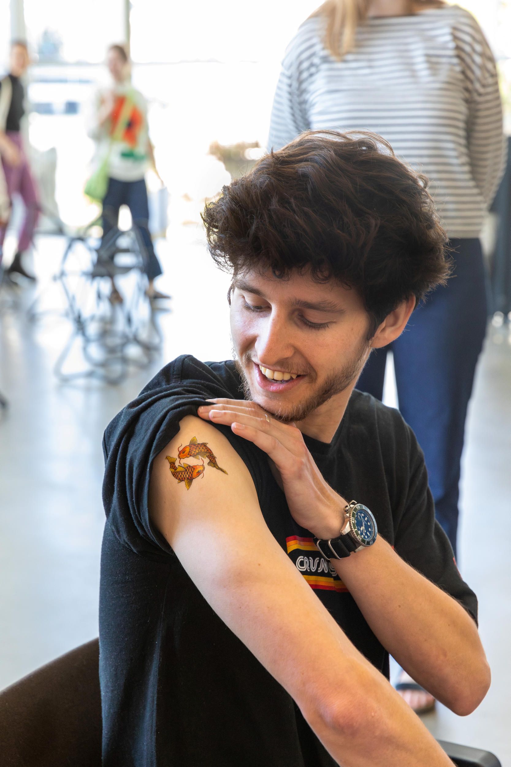 Visitor to eX de Medici's Tattoo Booth on opening weekend of eX de Medici: Beautiful Wickedness / June 2023 / Gallery of Modern Art, Brisbane / Photograph: C Baxter, QAGOMA