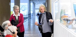 Visitors with hearing loss use assistive listening devices during a volunteer guided tour at the Queensland Art Gallery. Photograph: C. Callistemon