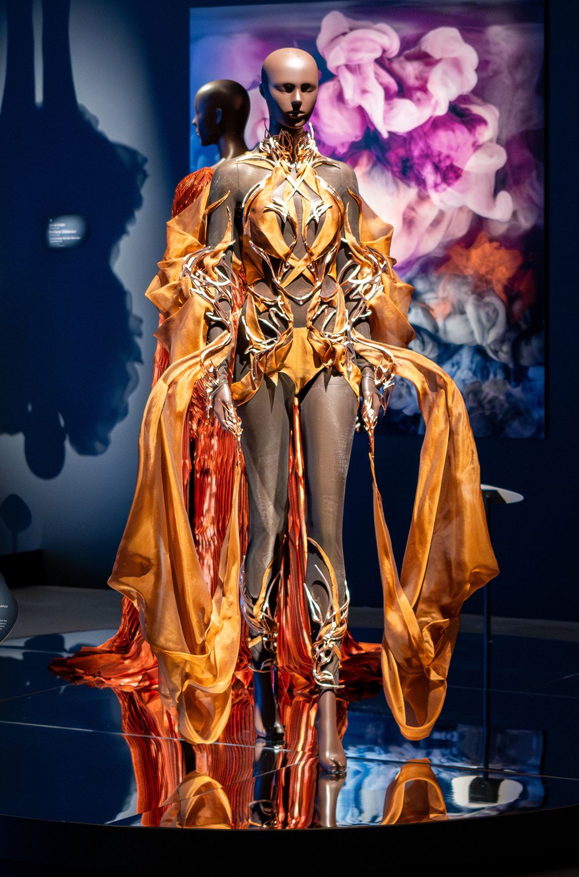 Iris van Herpen, Netherlands b.1984 / Eric Klarenbeek (Collaborator), Netherlands b.1978 / Maartje Dros (Collaborator), Netherlands b.1980 / Nicholas Koscinski (Collaborator), United States b.1992 / Singularity jumpsuit, from the ‘Meta Morphism’ collection 2022 installed in ‘Iris van Herpen: Sculpting the Senses’, GOMA 2024 / 3D-printed cacao shell blend, electroplated in copper; silk organza / Worn by model Winnie Harlow to the 2022 British Fashion Awards, London / © Iris van Herpen atelier / Photograph: C Callistemon © QAGOMA