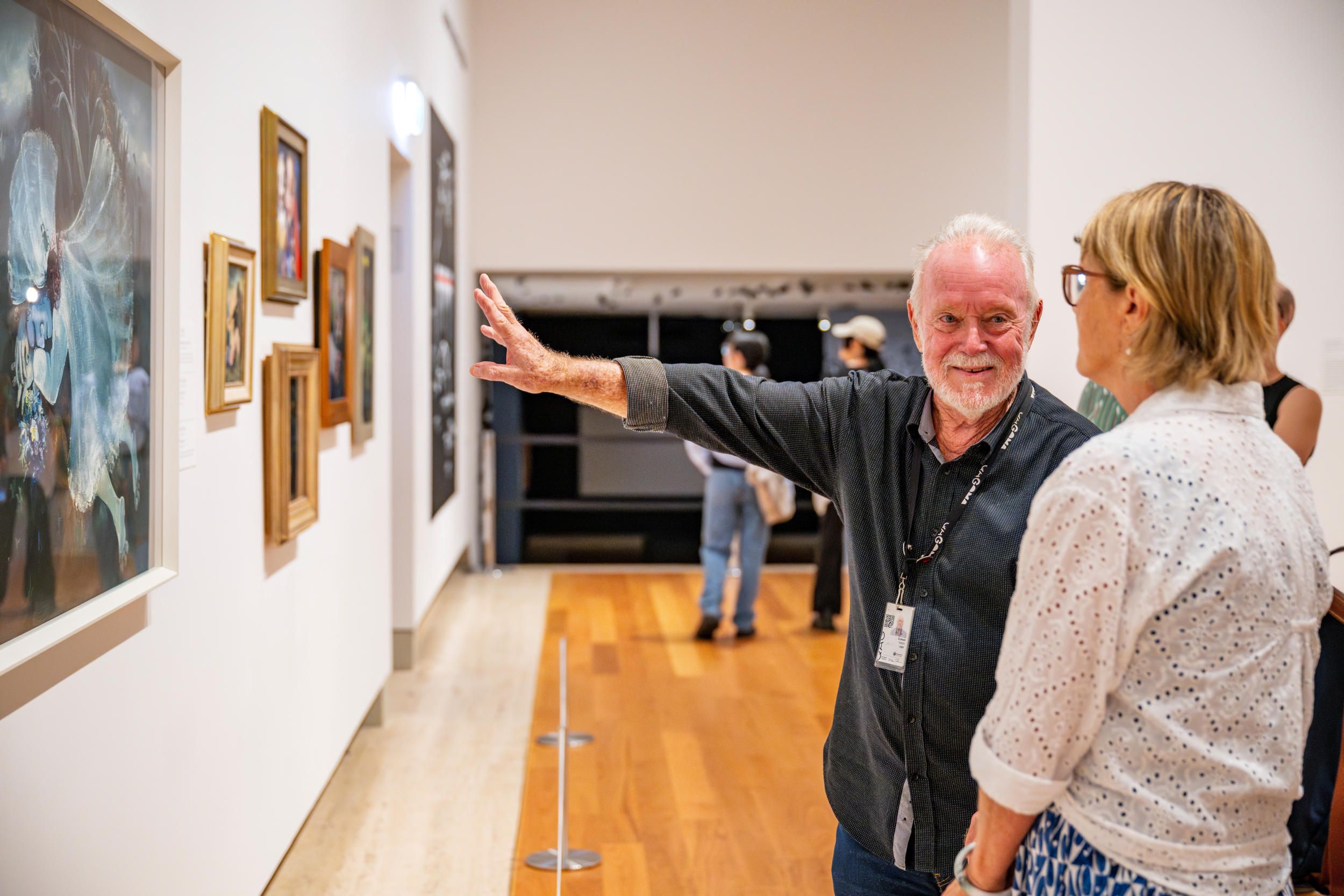 A Volunteer Guide engages visitors on a tour at the Queensland Art Gallery. Photography by Nicholas Umek | QAGOMA